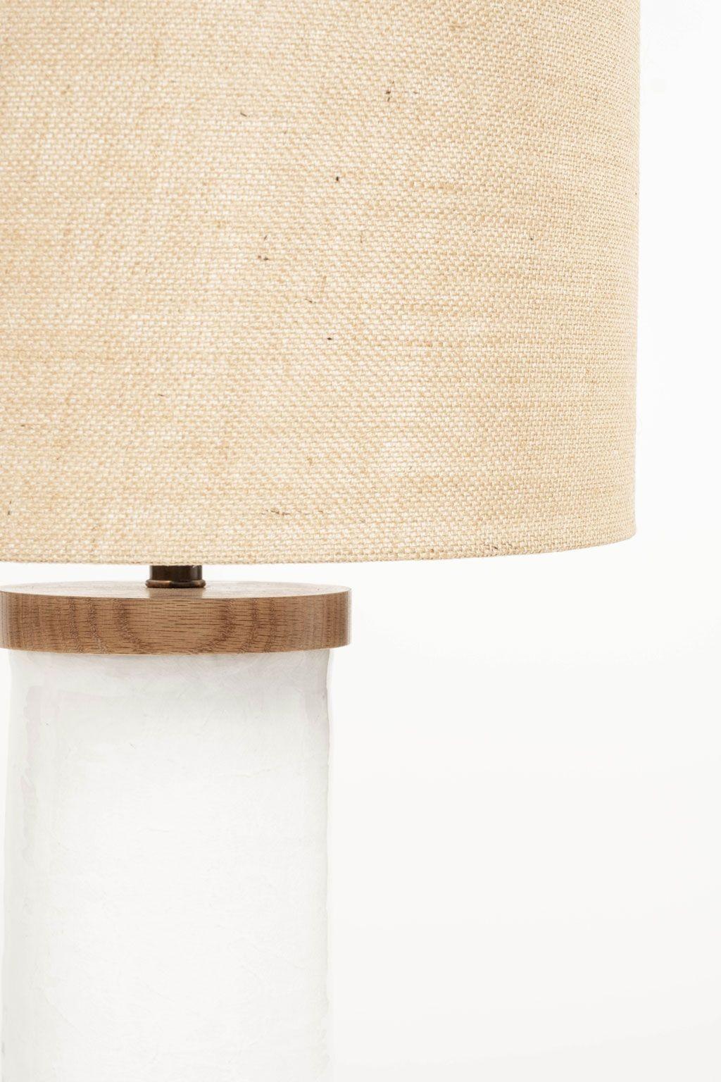 White cylinder-shape table lamp, custom-made from hand-thrown ceramic cylinder finished with wooden base and top. Newly wired for use within the USA using all UL listed parts. Lamp includes dimmer switch and complementary burlap shade. Listed