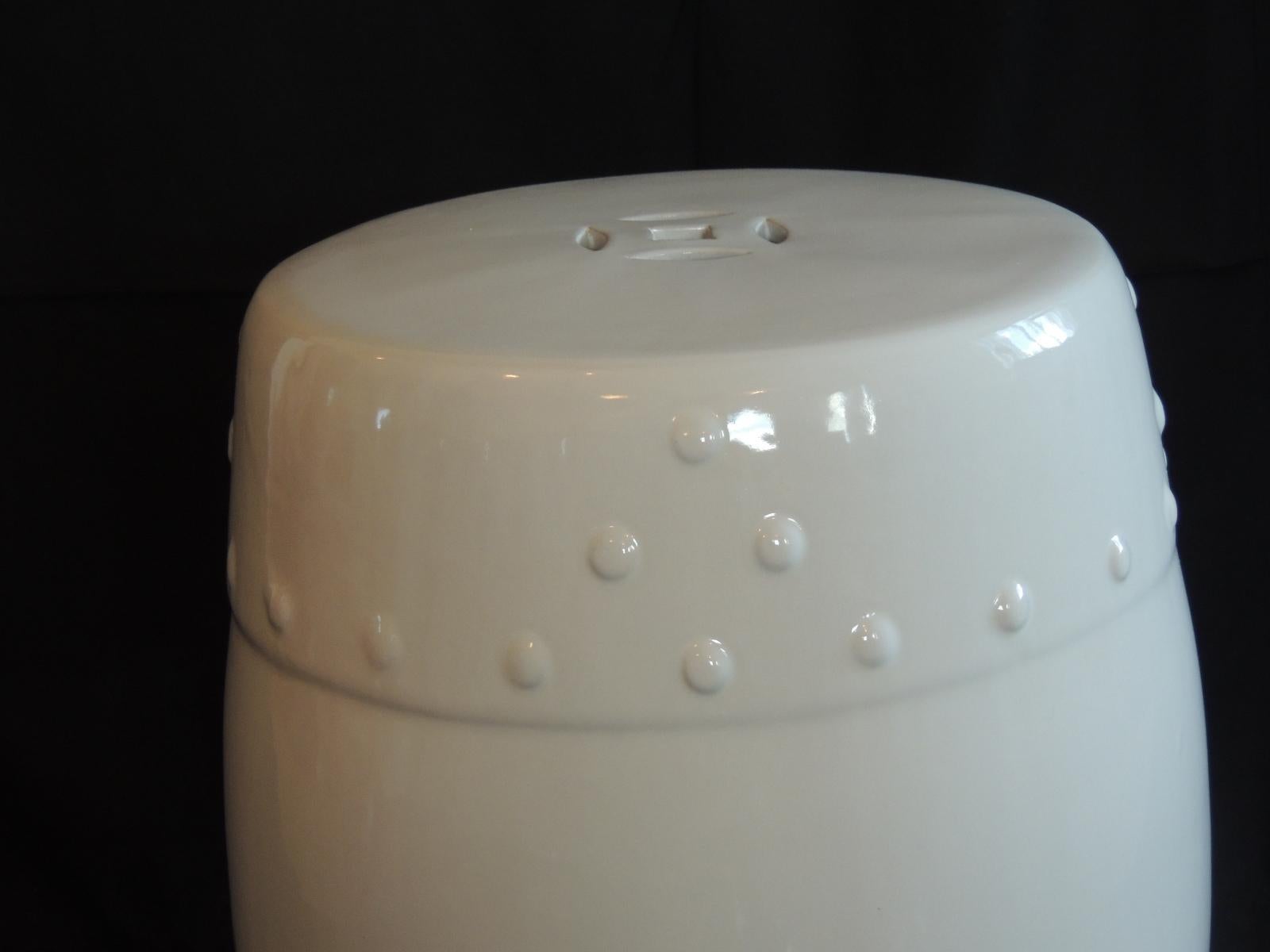 White glazed round Asian export ceramic garden stool.
Round garden stool with Asian pattern.
Could be used indoors and outdoors. Ideal as a stool or drinks table.
Size: 13” D x 18” H.
 