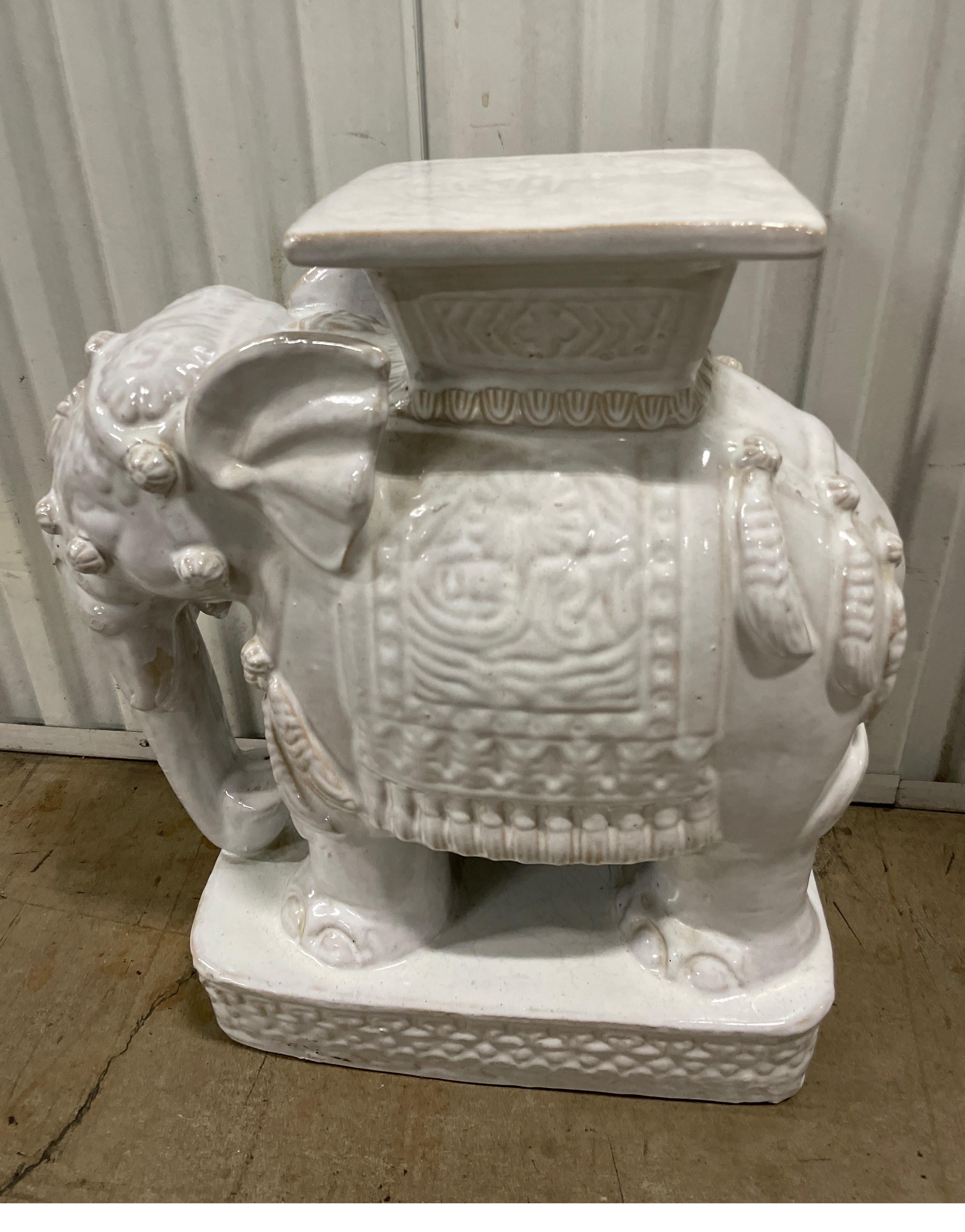 Majestic white terra cotta glazed elephant garden seat. This garden seat will look good in any setting inside or out.