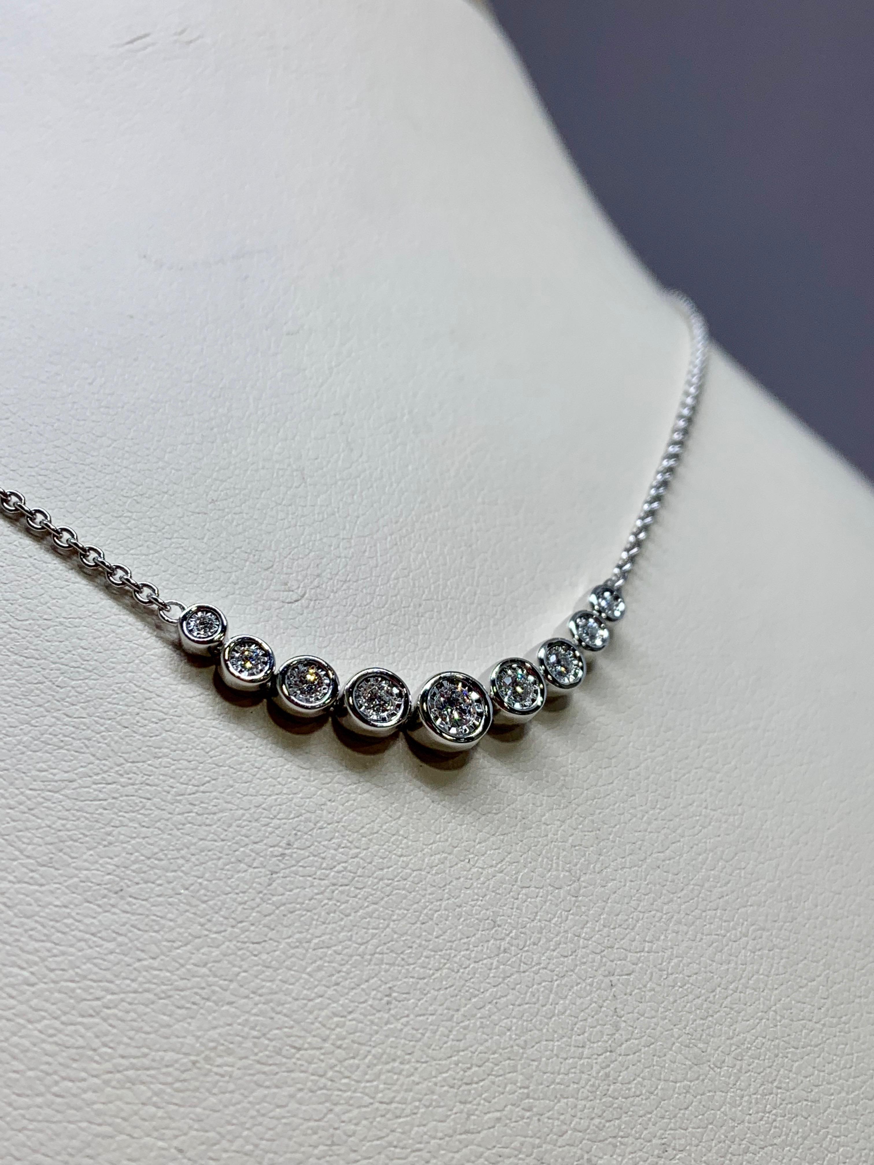 This classic bezel necklace features 9 round diamonds totaling 0.25 carats. The diamonds are fixed on a 14k white gold cable chain with a sturdy lobster claw clasp. The bezel settings are designed to be both flexible and comfortable to wear!