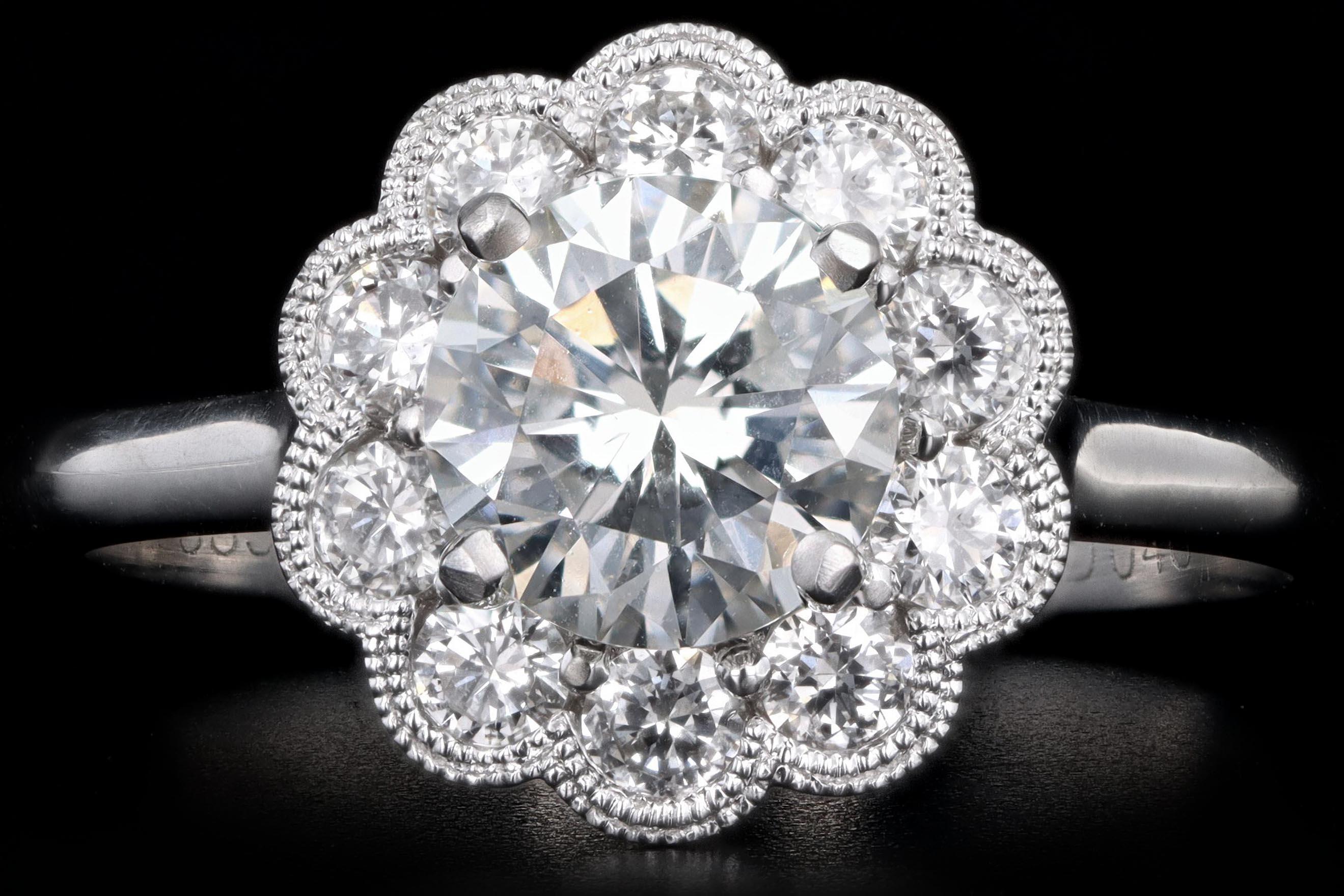 Era: Modern

Composition: 14K White Gold

Primary Stone: Round Brilliant Cut Diamond

Carat Weight: 1.13 Carats

Color/Clarity: E / SI1

GIA Report Number: 10041943

Accent Stone: Round Brilliant Diamonds 

Carat Weight: Approximately .2 Carats