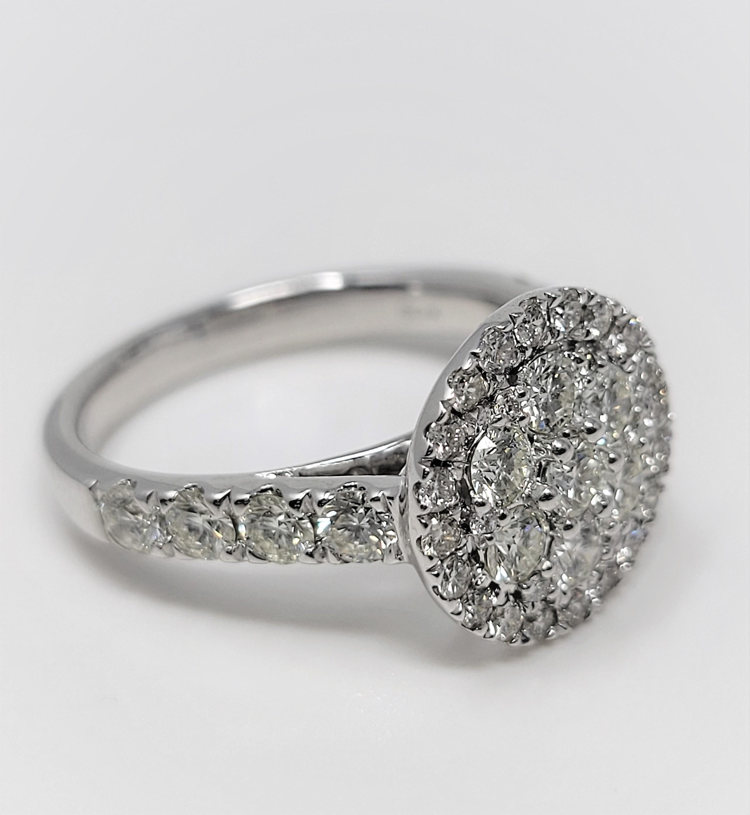 In 14 karat white gold, this lovely ring supports 1.50 carats of diamonds, VVS in clarity and J in color.  