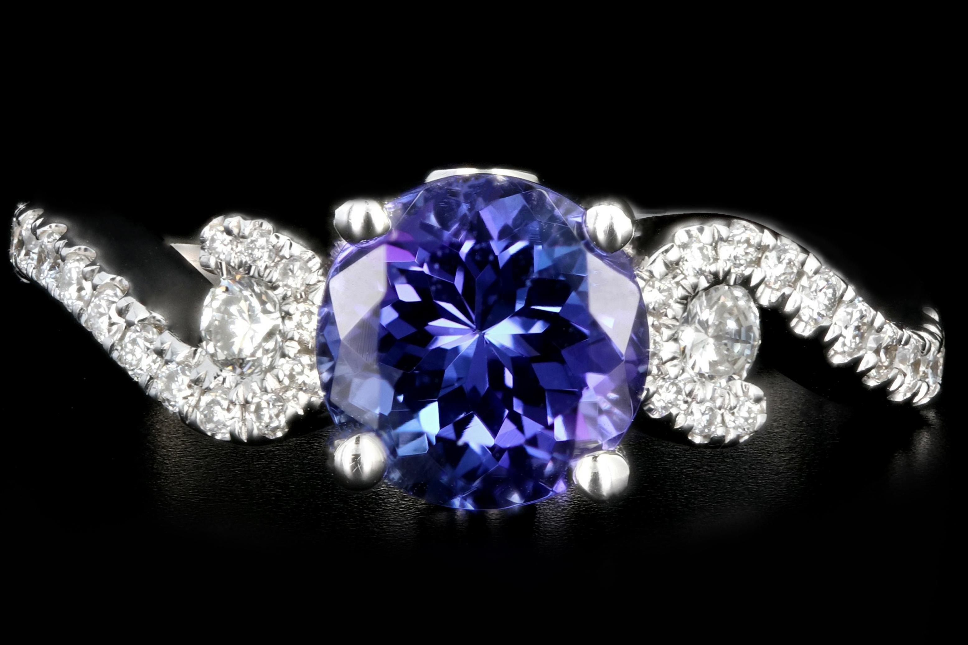 Era: Modern

Composition: 14k White Gold 

Primary Stone: Round Cut Tanzanite

Stone Weight: 1.63CT

Secondary Stone: 34 round brilliant cut diamonds

Stone Weight: .30 CTW

Color: G/H

Clarity: VS1/2

Ring Weight: 3.9 grams

Ring Size: 5.25