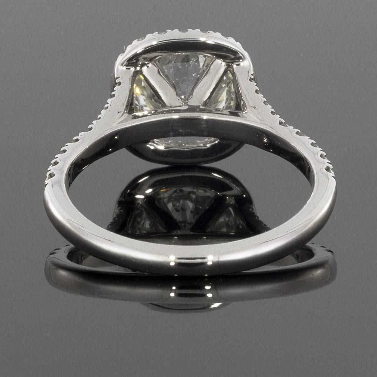 This beautiful diamond engagement ring features round brilliant diamonds with a 1.94 carat total weight. The center diamond is a 1.56 carat round diamond that grades as J/SI2 in quality. It is prong set in a 14 karat white gold setting. The diamonds
