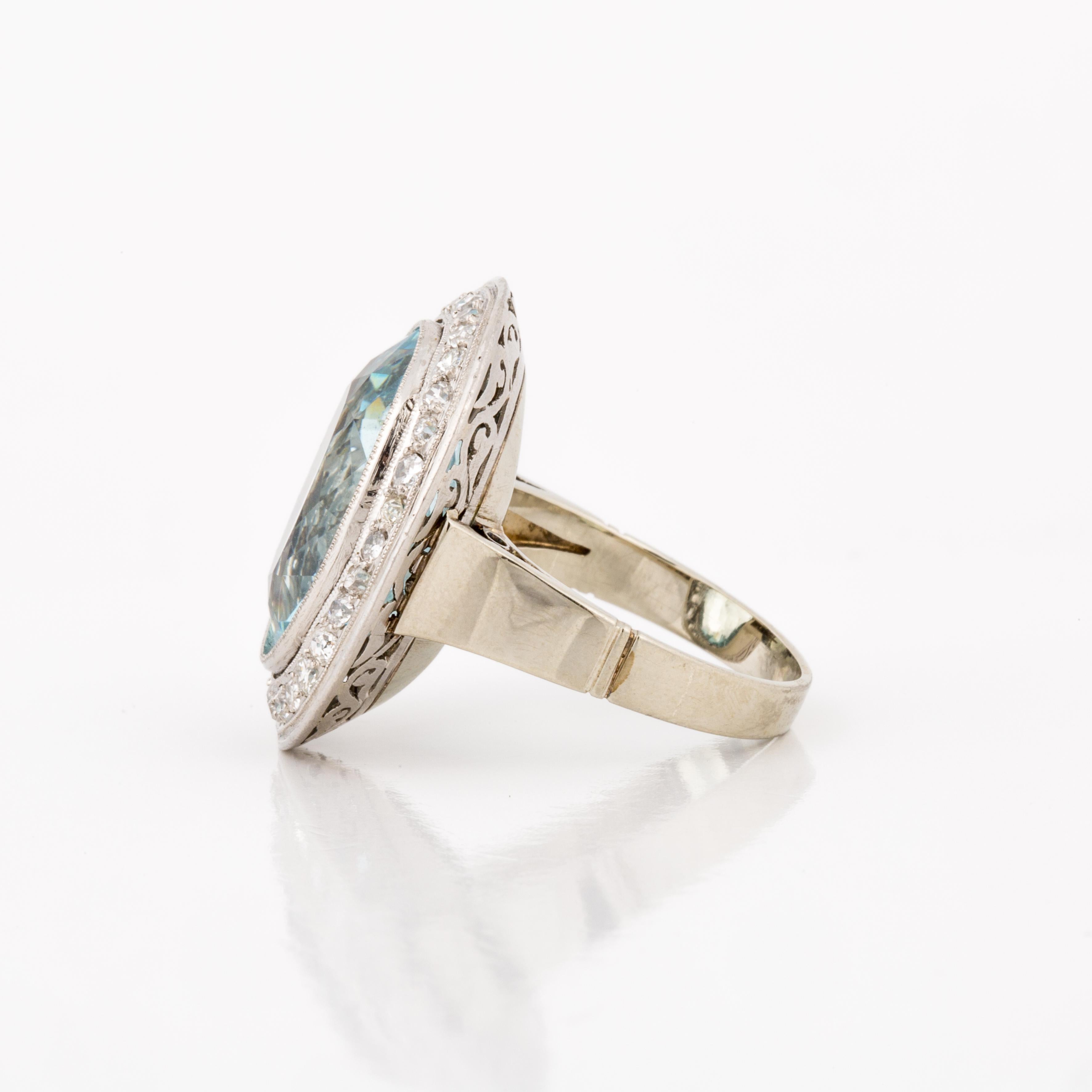 18K white gold ring featuring an oval faceted aquamarine accented by round diamonds.  The aquamarine totals 15 carats.  There are 32 round diamonds that total 1.25 carats; G-I color and VS2-1 clarity.  Presentation area measures 7/8 inches long and