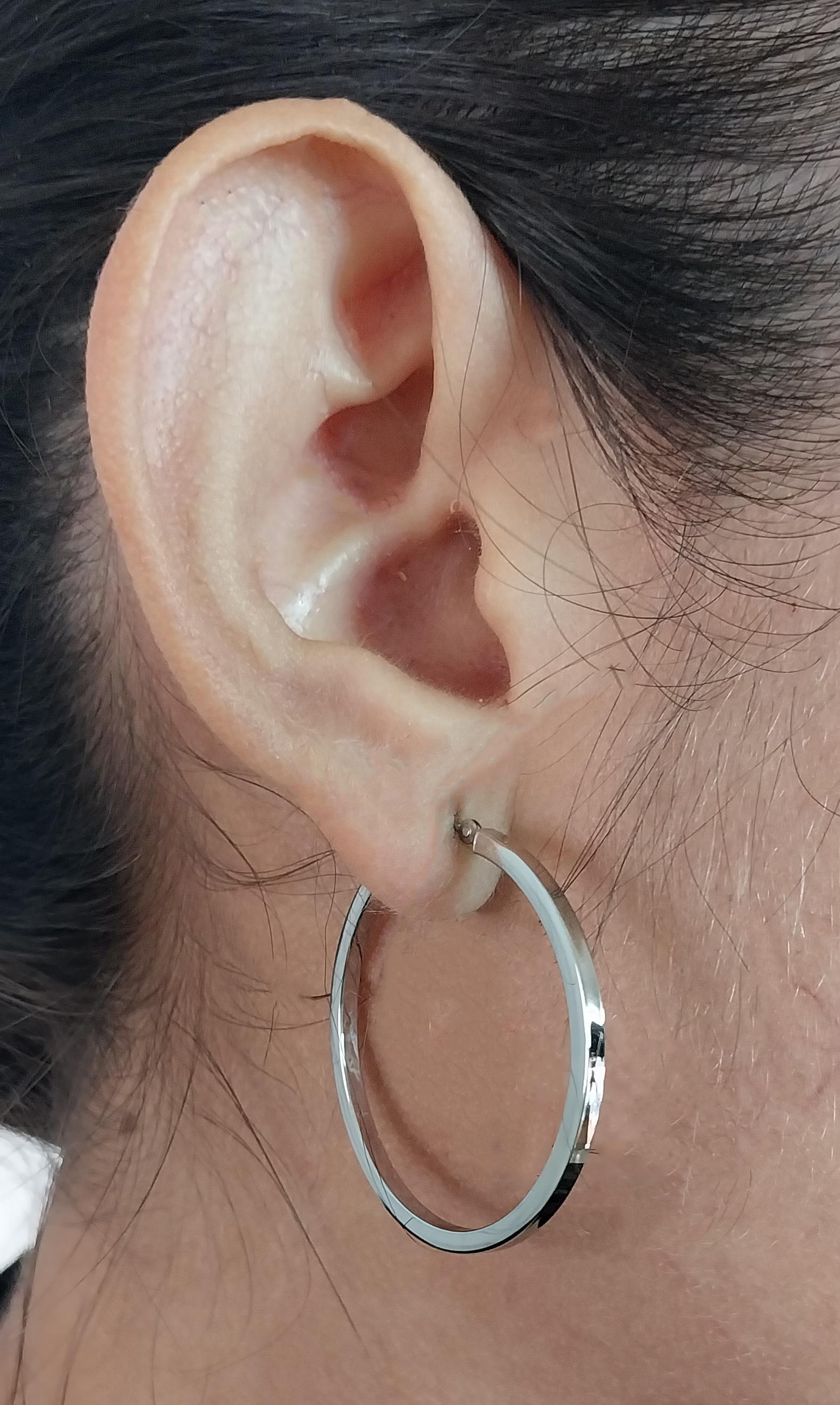 14 Karat White Gold 2mm Hoop Earrings with a 1.5 Inch Diameter and Square Edges. Pierced Post with Hinged Clip Closure. Finished Weight is 2.5 Grams.