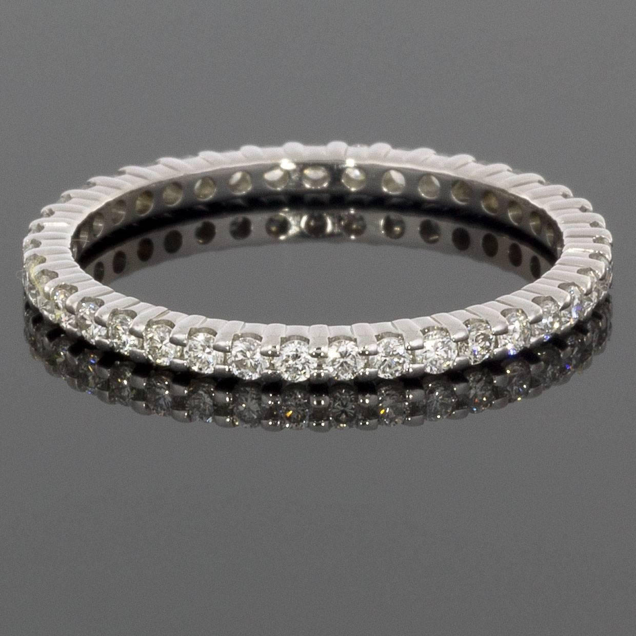 This classic band is a beautiful 14 karat white gold diamond eternity band that can dress up any ring. It can be used as a wedding band, stand alone band, or stack ring. The ring has round brilliant cut diamonds that have a combined total weight of