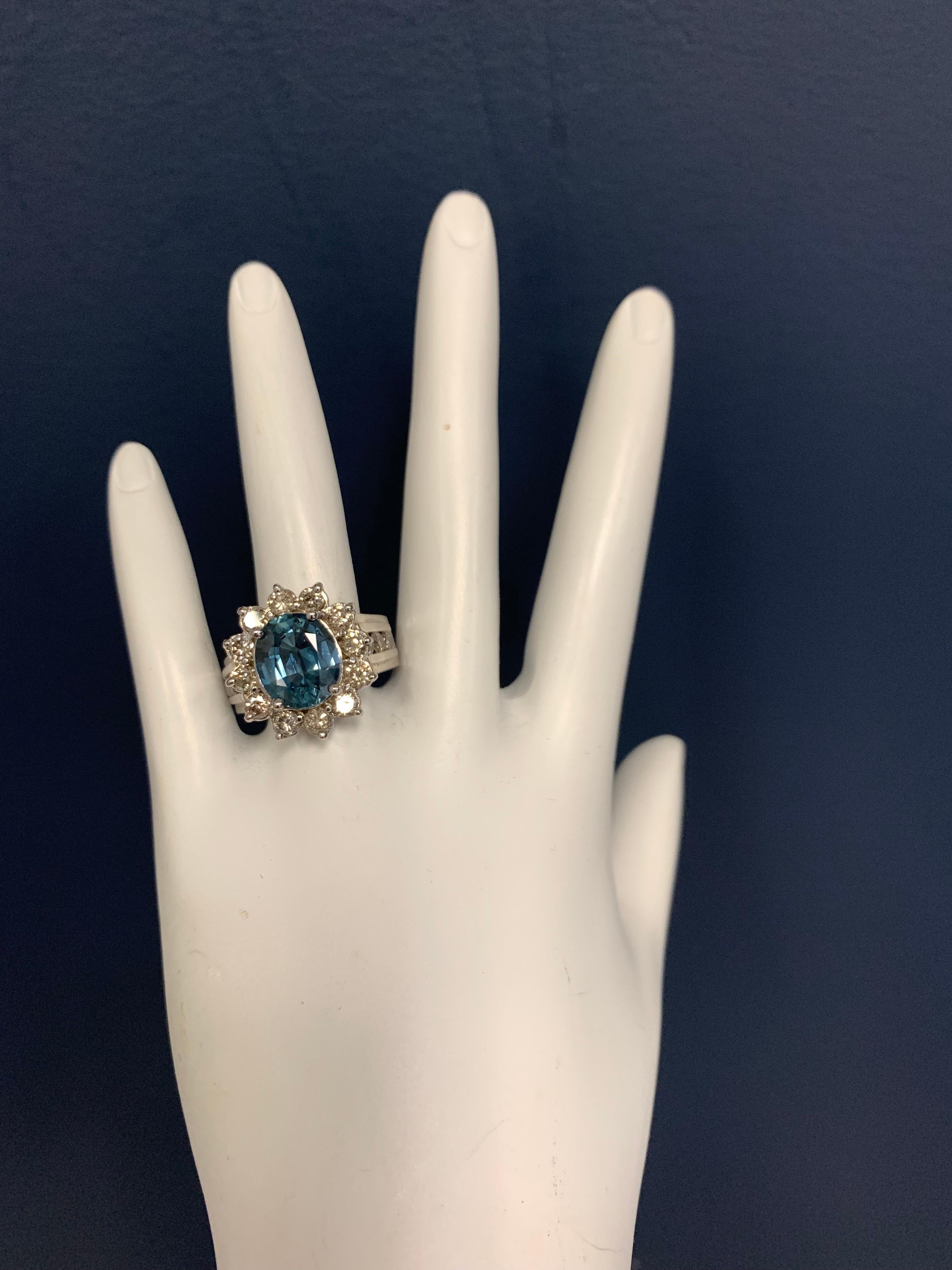 A magnificent 14k White Gold Oval Natural Sapphire and Diamond Cocktail Ring (size 7). Set in the center is a 4.97 carat Oval Sapphire measuring 11.24x9.45x5.37mm. The mounting is set with 18 Natural Round Brilliant Diamonds graded approximately as