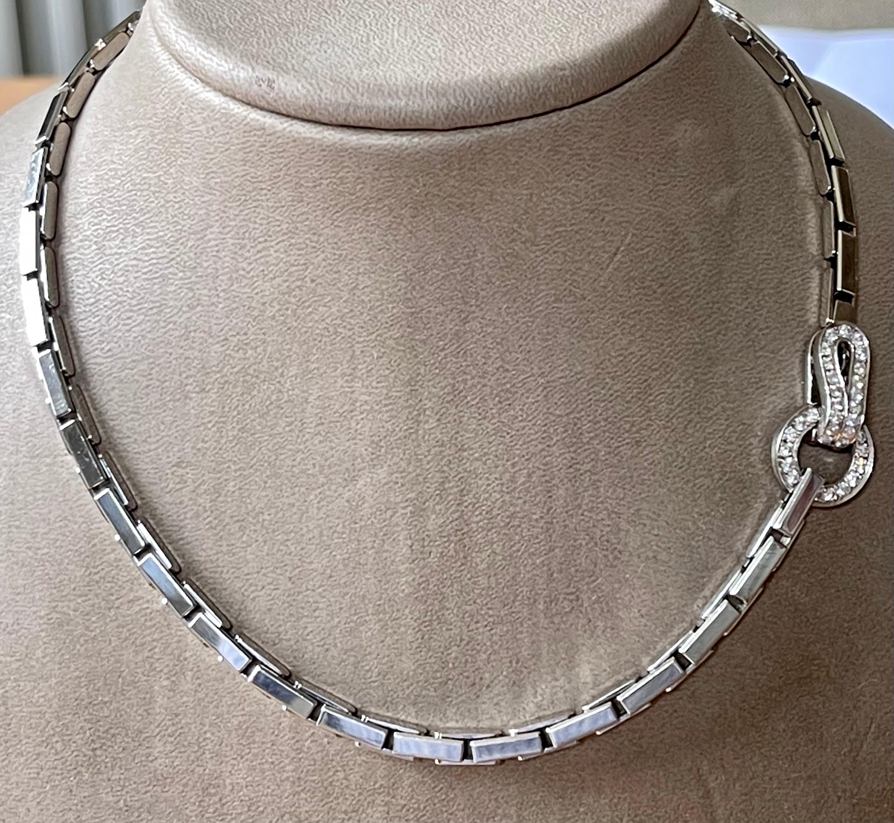 This Necklace by Cartier is from their Agrafe collection and features a circle link design with round brilliant cut Diamonds made in 18k white Gold. This Necklace has a hook design clasp where the diamond circle links interlock. Set with 35 round