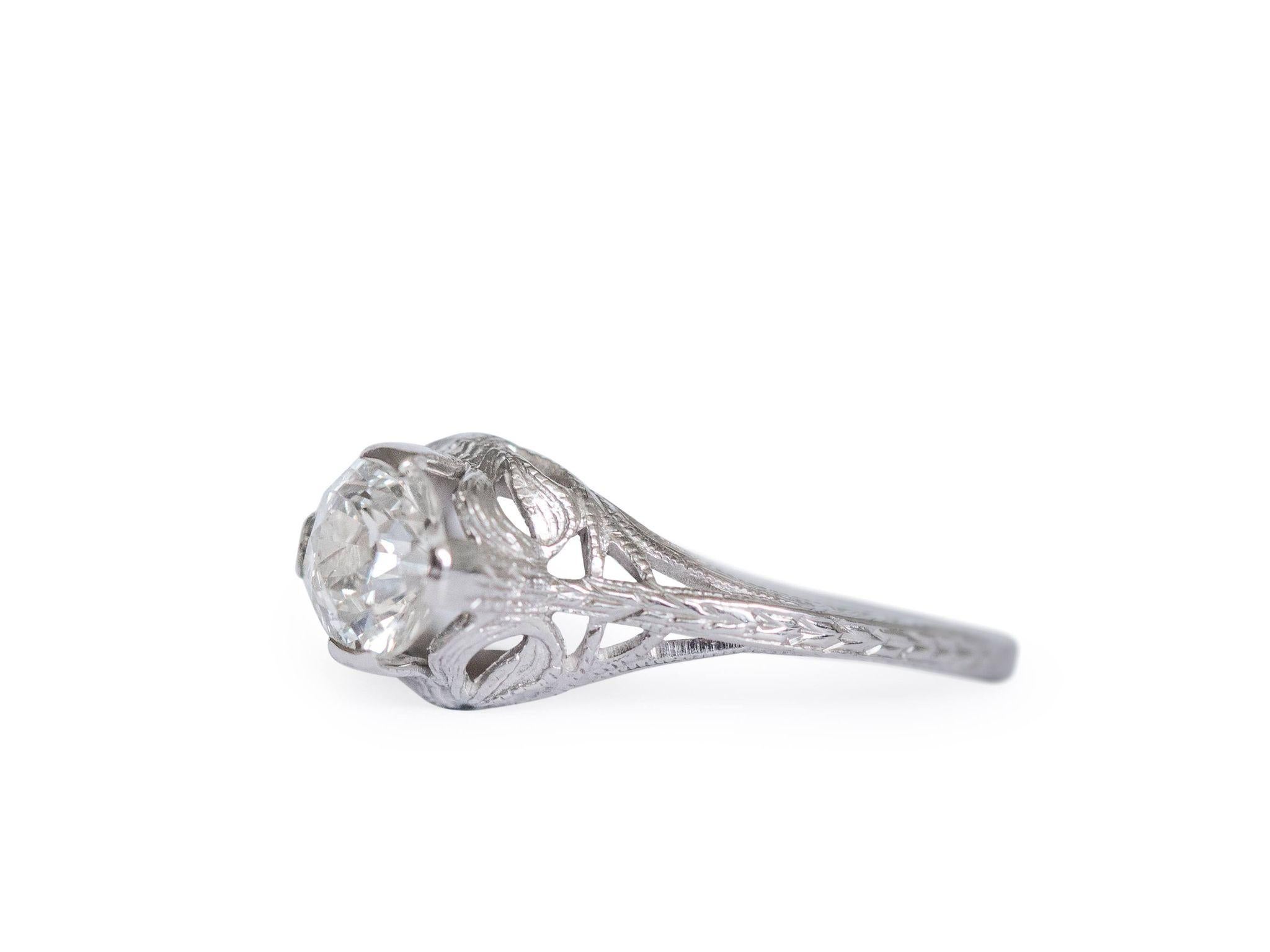 This Art Deco solitaire is a fine example of a filigree solitaire engagement ring crafted in 18 karat white gold. The old european cut diamond is held high in four prongs showcasing the solitaire from all sides! Flowing down from the sparkling