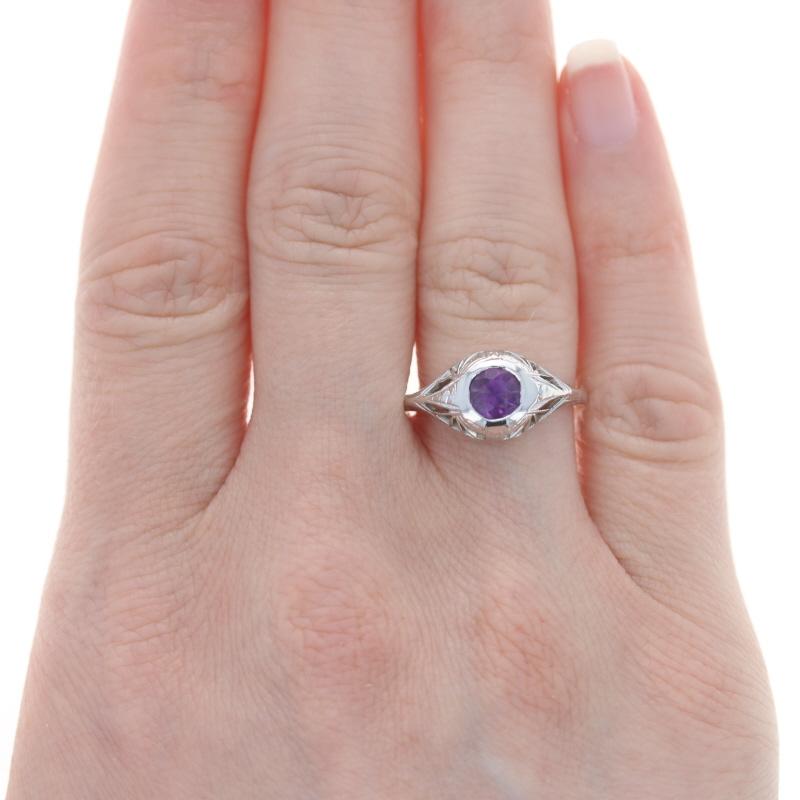 Size: 6 3/4
Sizing Fee: Down 1 size & up 1 size for $35

Era: Art Deco
Date: 1920s - 1930s

Metal Content: 14k White Gold

Stone Information

Natural Amethyst
Carat(s): .40ct
Cut: Round
Color: Purple

Total Carats: .40ct

Style: Solitaire 
Features: