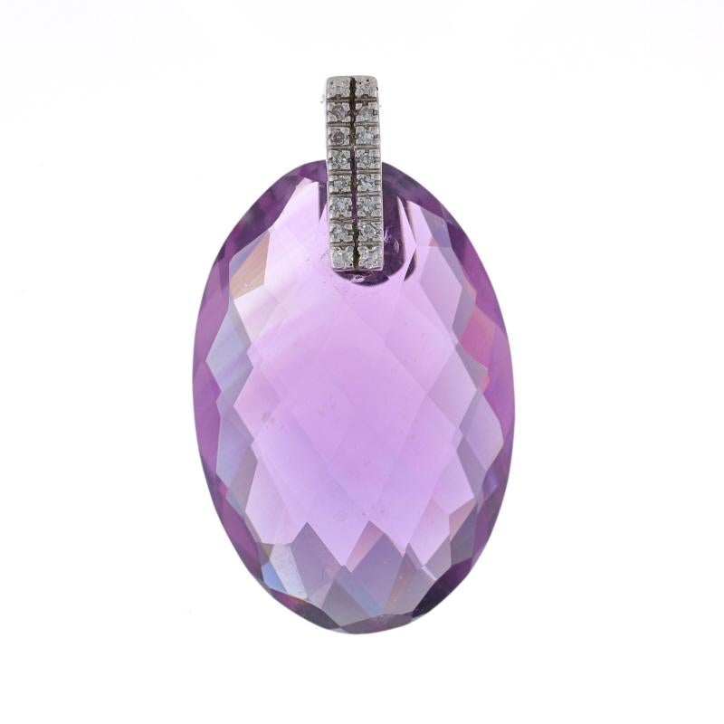 Metal Content: 14k White Gold

Stone Information
Natural Amethyst
Carat(s): 31.50ct
Cut: Oval Checkerboard
Color: Purple

Natural Diamonds
Carat(s): .08ctw
Cut: Single
Color: G - H
Clarity: SI1 - SI2

Total Carats: 31.58ctw

Measurements
Tall (from