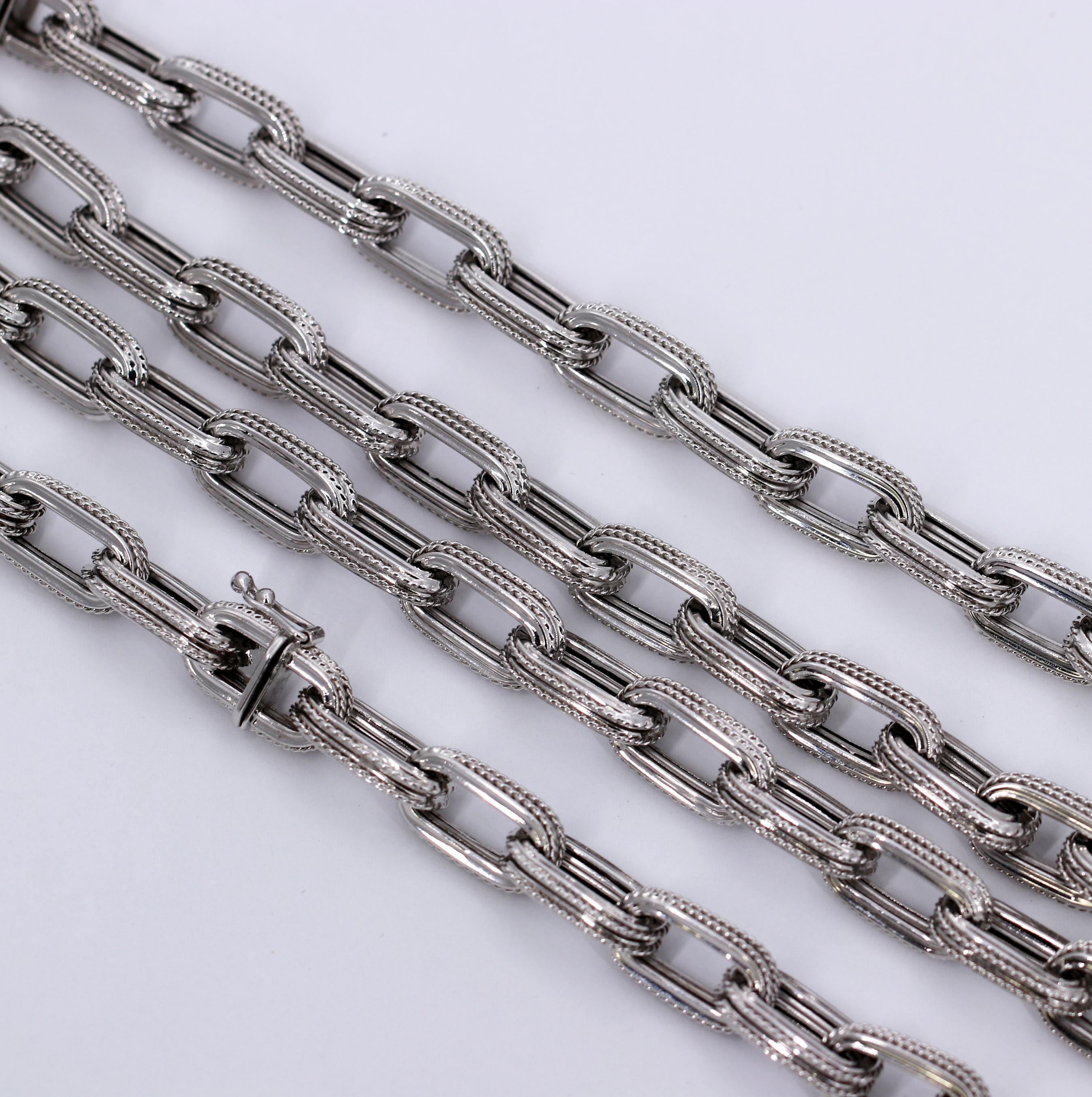 A 44.5 inch long chain made by OTC, in 18K white gold, with a twisted rope edge. Able to be broken into three sections:  two sections measure 18 1/2 inches each, and the
third section measure 7.5 inches (can be worn as a bracelet). Marked 18KT OTC