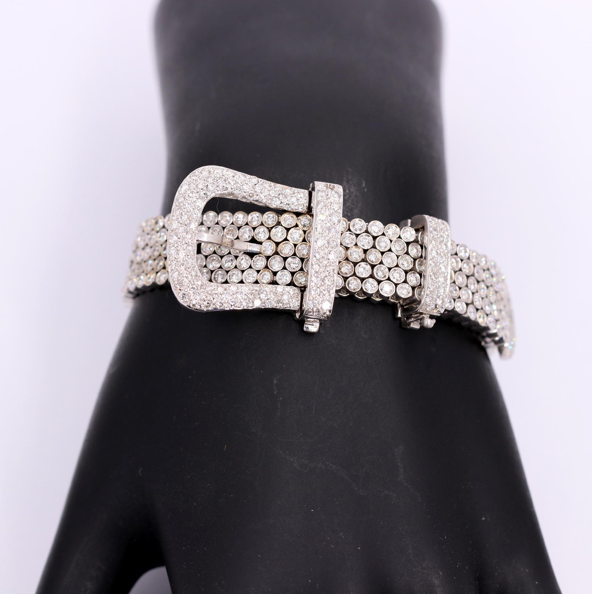 A ladies white gold bracelet with a buckle design, set with 540 round brilliant cut diamonds. The body of the bracelet measures 1/2 an inch wide, and the buckle measures 7/8 of an inch wide. This fabulous bracelet scintillates with a total of