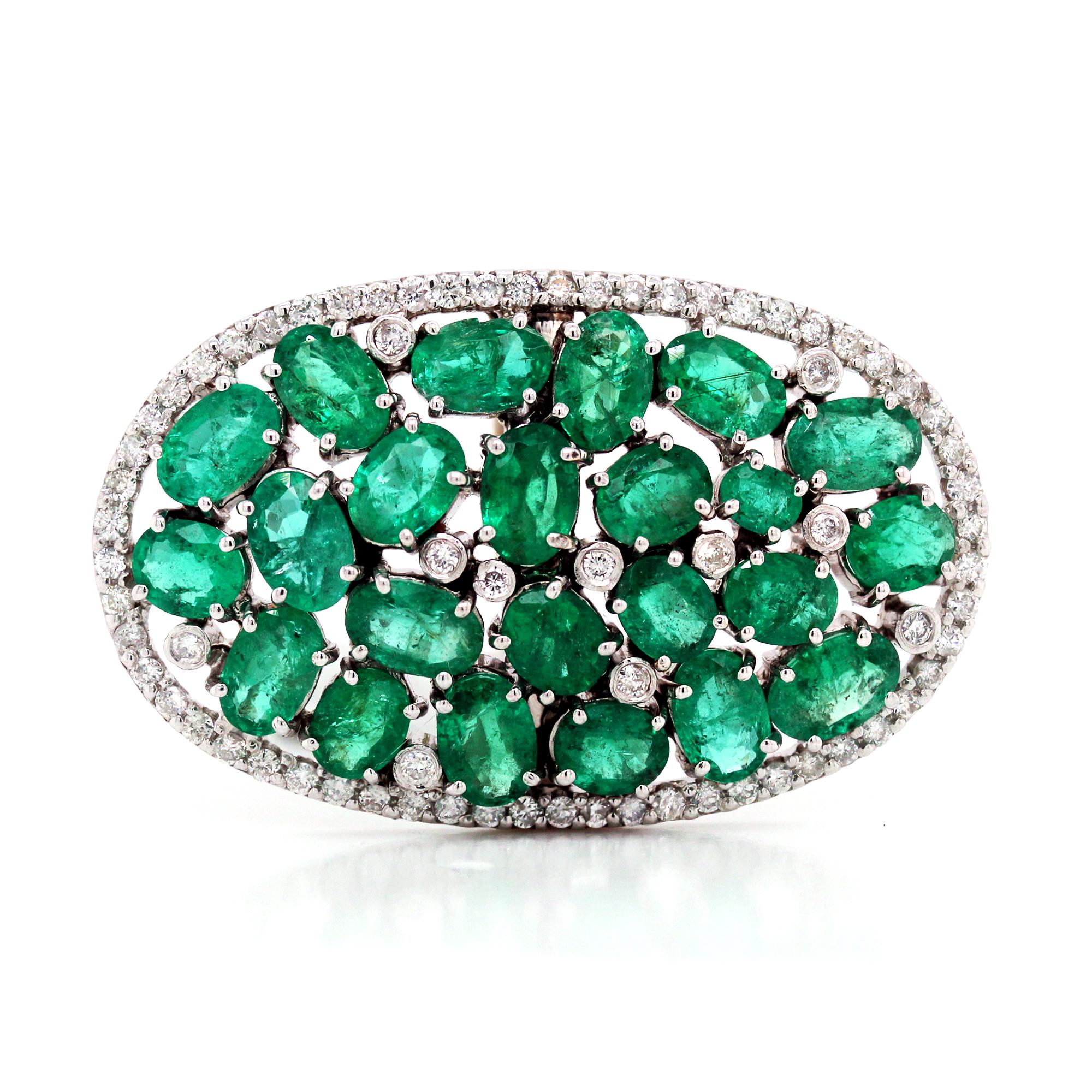 14K White Gold and Diamond Cluster Ring with Emeralds

Emeralds are oval cuts, 23 total. Sizes vary, apprx. 20 carat total weight. Emerald origins are unknown, but we believe them to be Zambian.

Apprx. 1 carat diamonds total weight. 

Ring face is