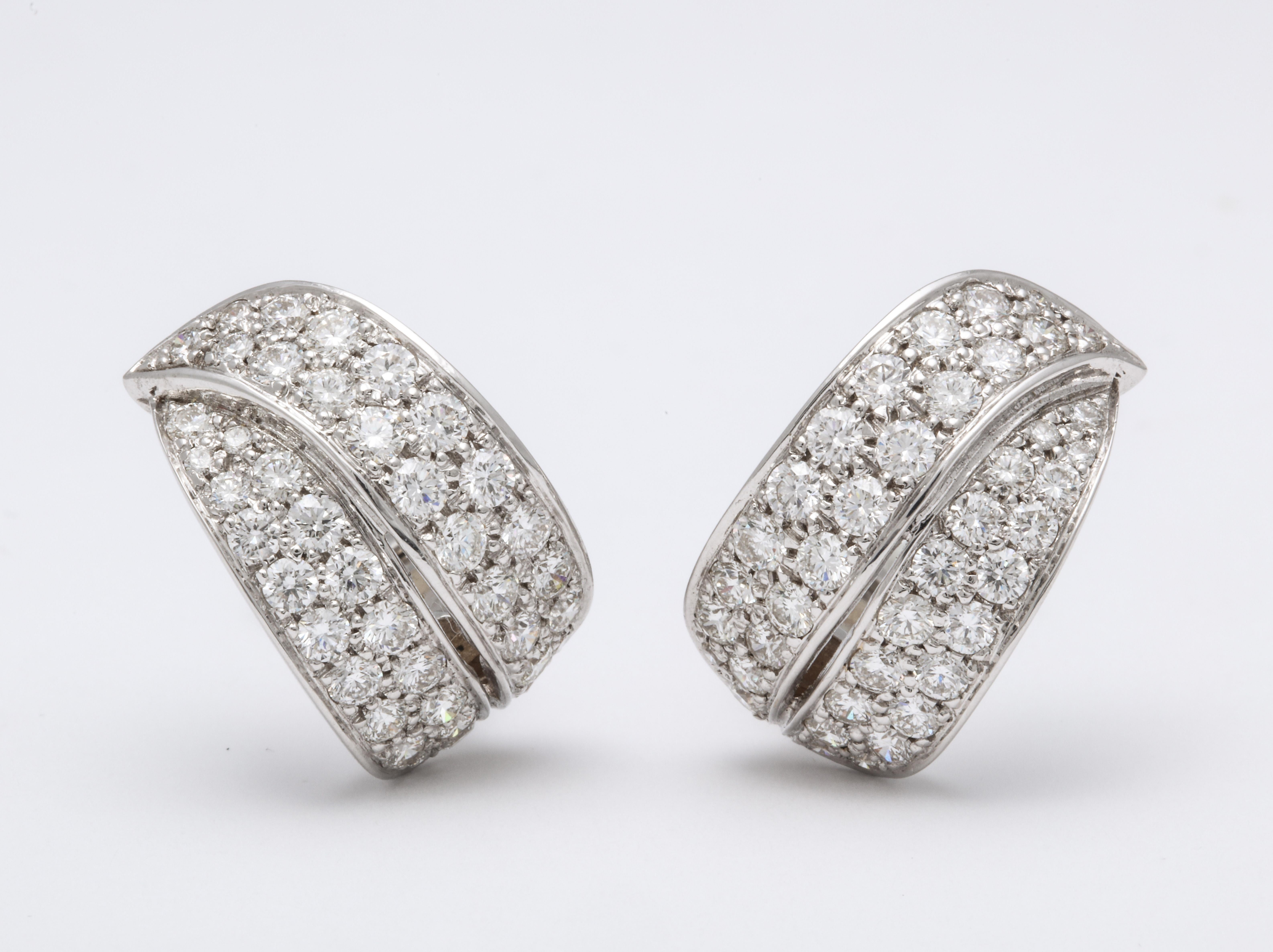 Chic yet easy 18K white gold stylized ''partial'' hoop earrings decorated with colorless round brilliant-cut pave'-set diamonds: 3.82 carats.  These earrings have a LEFT and RIGHT ear orientation.  
Earrings are fabricated with French clips and can