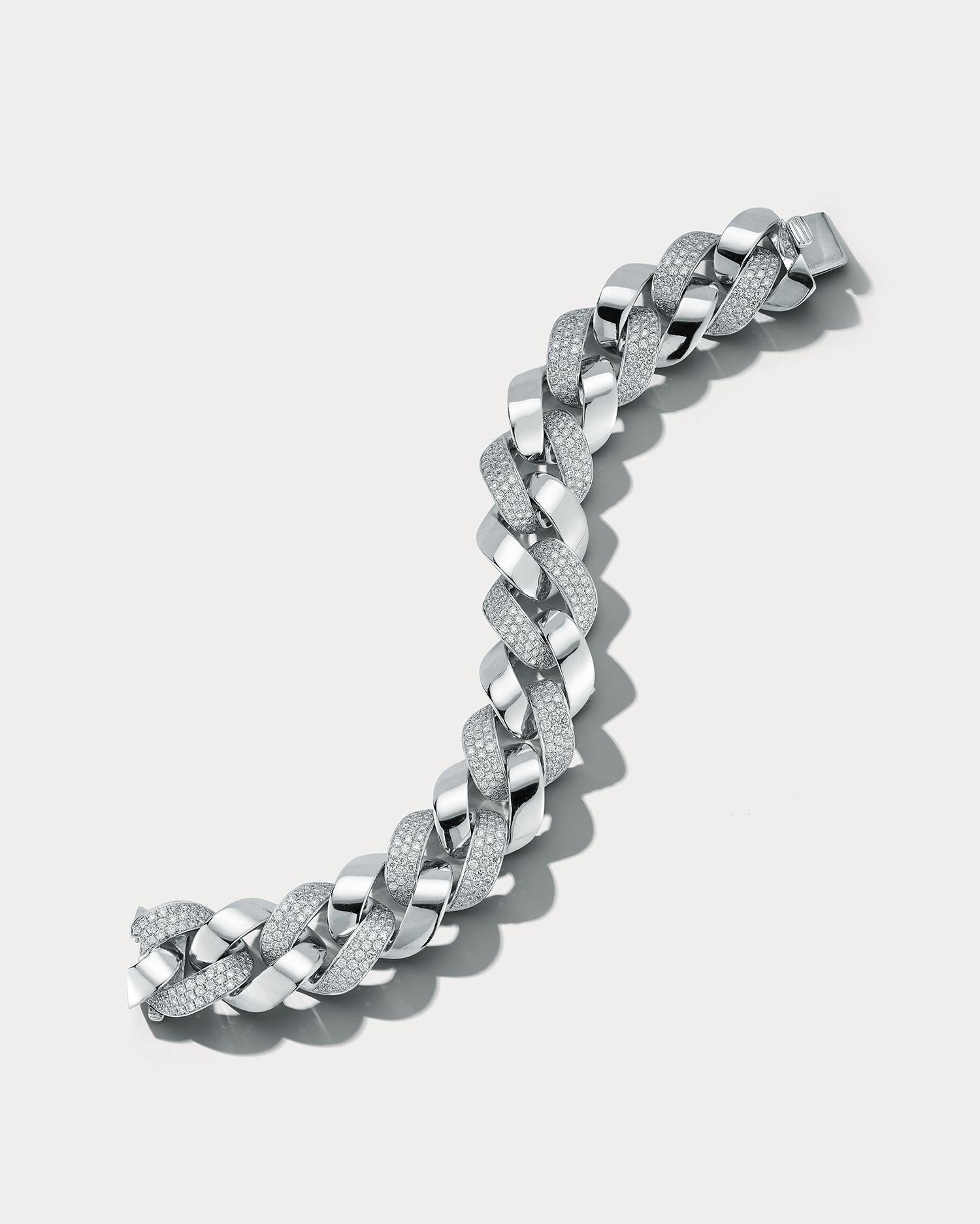 This exquisite Cuban link bracelet is a true statement piece that combines the luxury of white gold with the brilliance of diamonds. The bracelet is crafted from high-quality white gold, which has a bright and lustrous appearance that complements