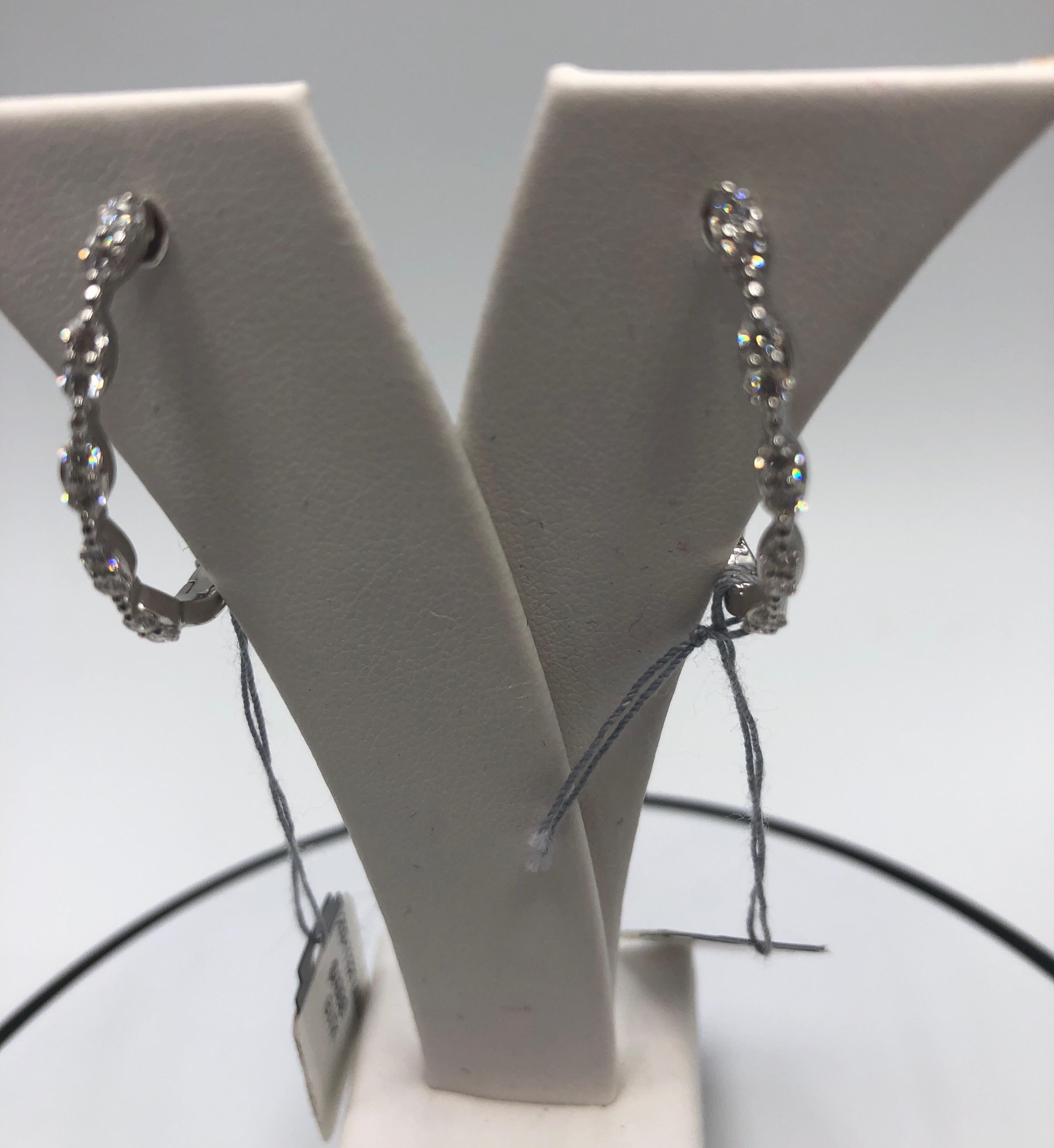 18K White Gold and Diamond Hoop Earrings made by Jye's International.  There are 32 Round Diamonds in U Shaped Hoop Design.  These stunning earrings are made by Award Winning Designer Jye's International.  