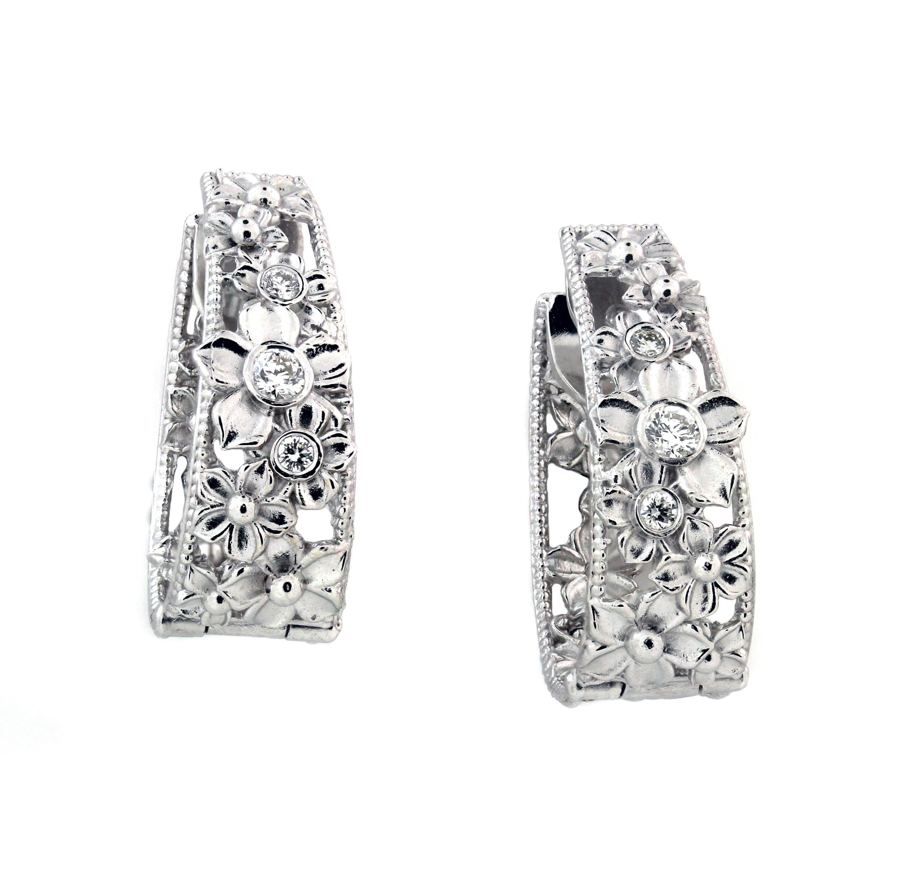 Stambolian 18K White Gold and Diamond Inside Out Floral Hoop Earrings 

These are inside-out earrings with diamonds set on face of earrings and floral design continuing on the interior.

0.34ct. G color, VS clarity diamonds. 6 total