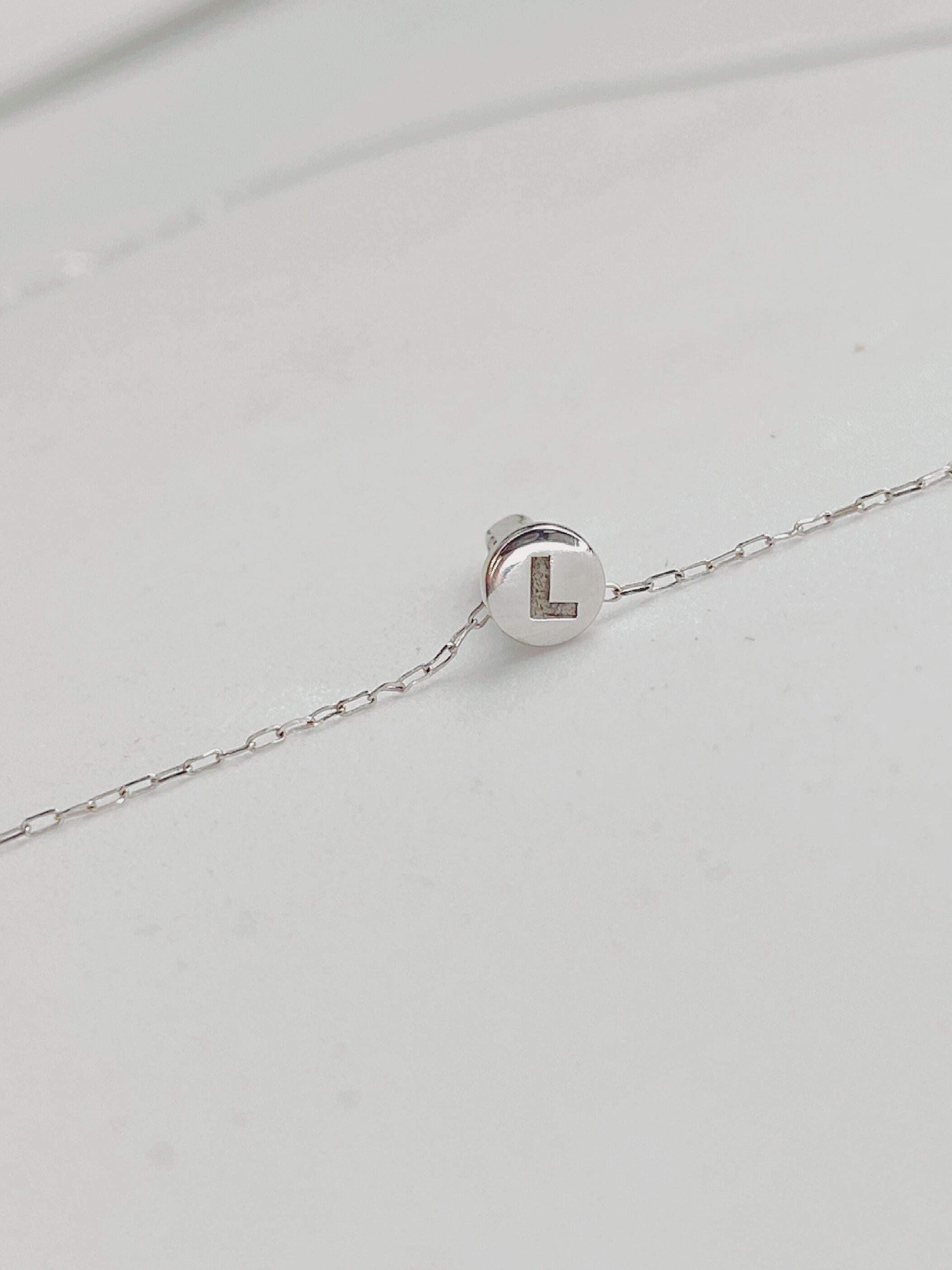This captivating 18k white gold chain and pendant features a nail set with full cut natural Diamonds.  Each pendant is custom made and engraved with the letter of your choice. These “ Though as nails” necklaces are both delicate, edgy and most