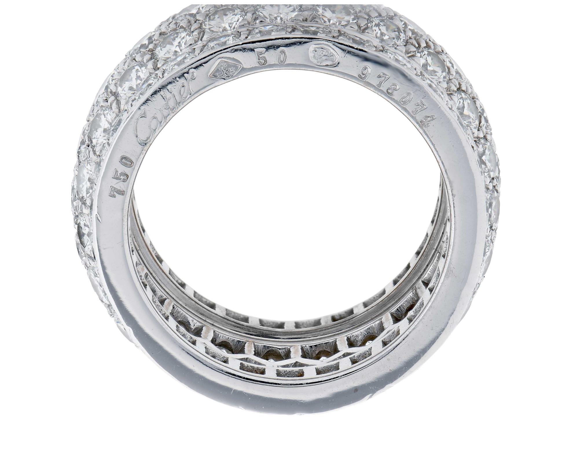 A band ring composed of five rows of pave-set diamonds, with a raised center; mounted in 18-karat white gold, with French assay marks 
• 122 brilliant-cut diamonds, F to VS or better, total weighing approximately 5.5 carats
• Signed Cartier,