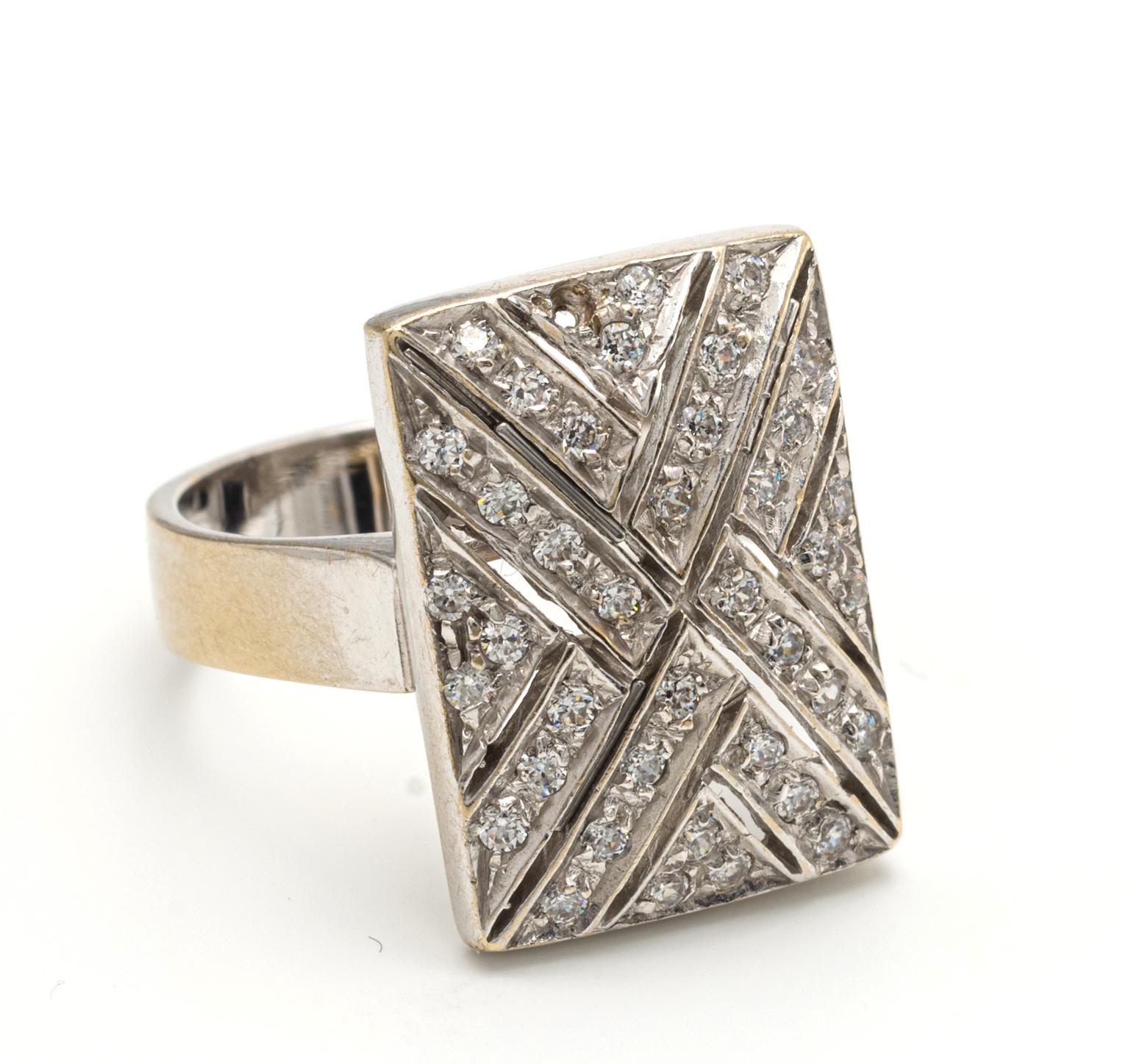 White Gold and Diamond Ring
Of rectangular design, set with a criss cross of round diamonds, Diamonds weighing a total of approximately 1.20 carat, 14 karat white gold, Size 7.