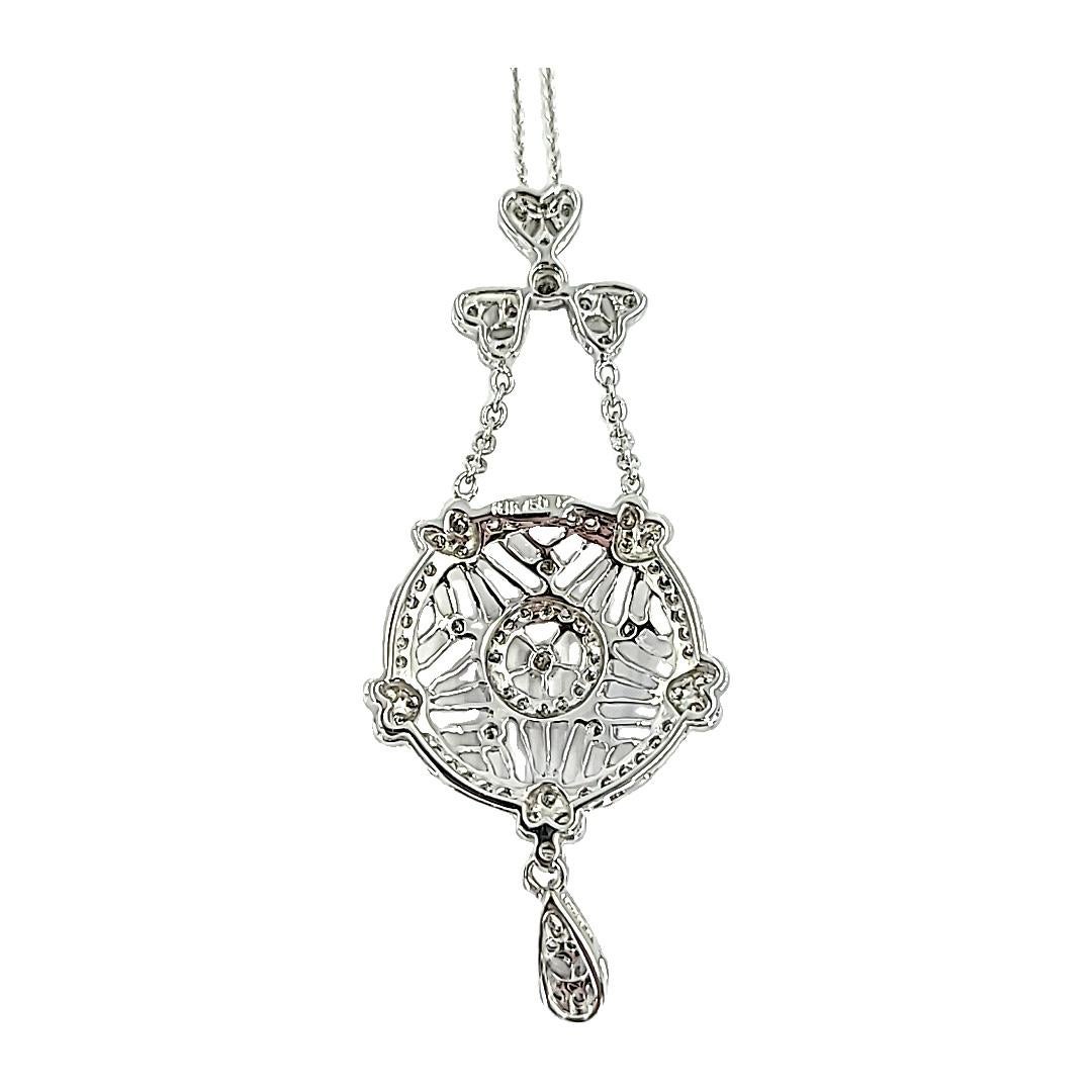 Feminine 18 Karat White Gold Slide Pendant Necklace with Heart Accents Featuring 83 Round Diamonds of SI Clarity and H/I Color Totaling Approximately 0.70 Carats. Openwork Swing Design with Millgrain Edge. 16 Inch Chain with 2 Inch Long Pendant. 