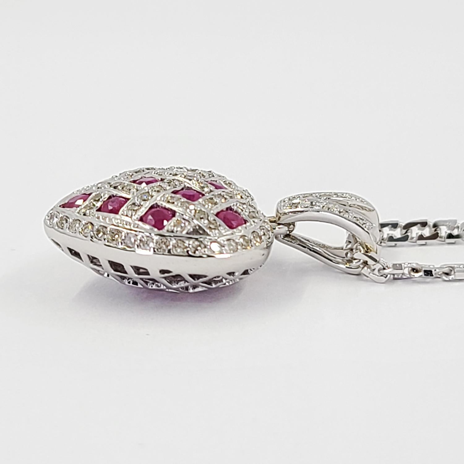 14 Karat White Gold Puff Heart Pendant Featuring 11 Round Rubies Totaling Approx. 1 Carat & 91 Single Cut Diamonds Of I1 Clarity & J Color Totaling 0.45 Carats. Finished Weight Is 5.8 Grams. Chain not included.