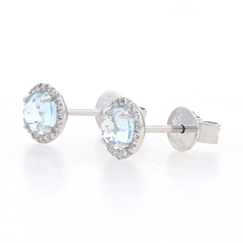 Metal Content: 14k White Gold

Stone Information
Natural Aquamarines
Treatment: Heating
Carat(s): .68ctw
Cut: Round Rose
Color: Blue

Natural Diamonds
Carat(s): .08ctw
Cut: Single
Color: F - G
Clarity: VS1 - VS2

Total Carats: .76ctw

Style: Halo