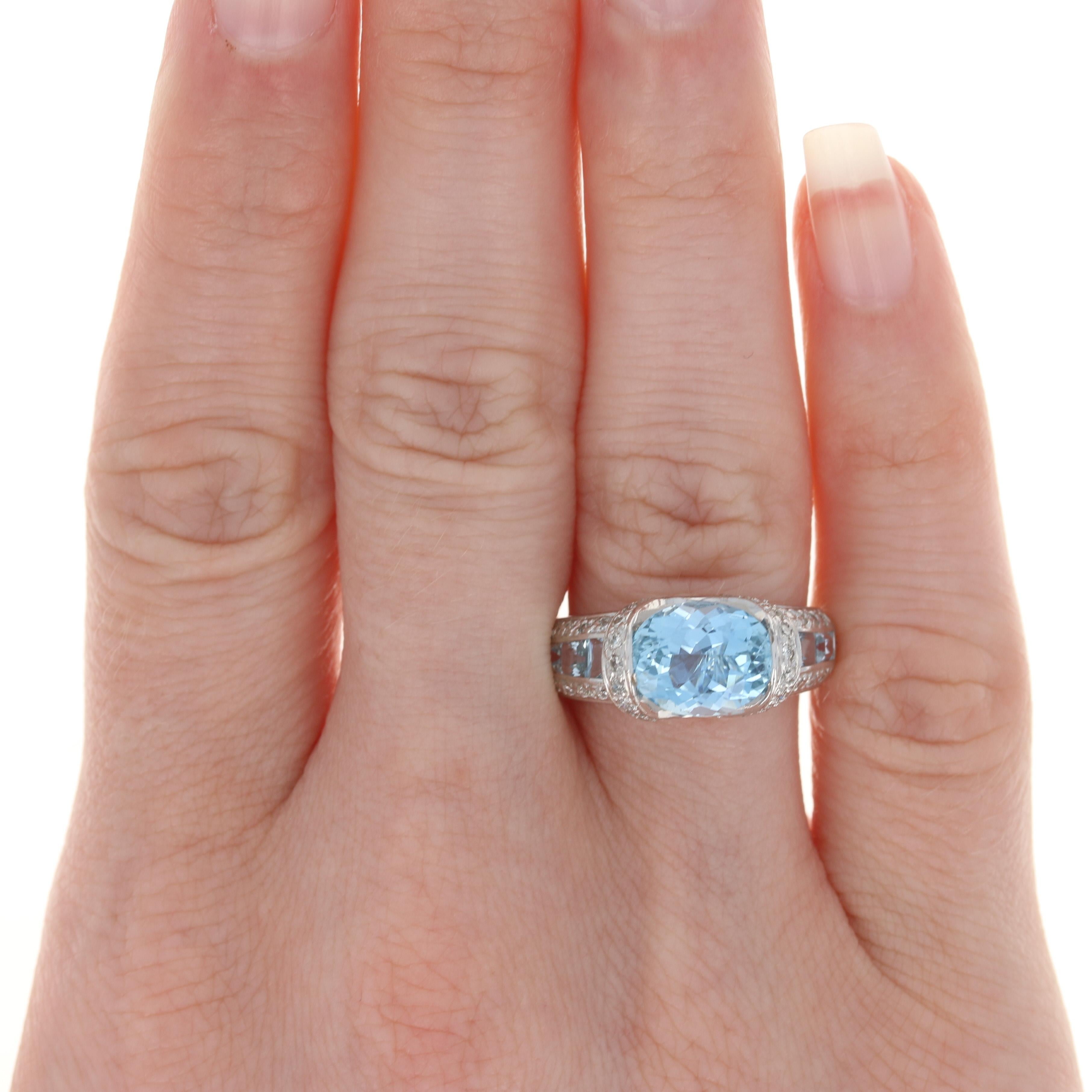 Size: 7

Metal Content: 14k White Gold

Stone Information: 
Genuine Aquamarine Solitaire
Treatment: Heating
Carat: 2.25ct 
Cut: Oval
Color: Blue

Genuine Aquamarine Accents
Treatment: Heating
Carats: 1.20ctw 
Cut: Square 
Color: Blue

Natural