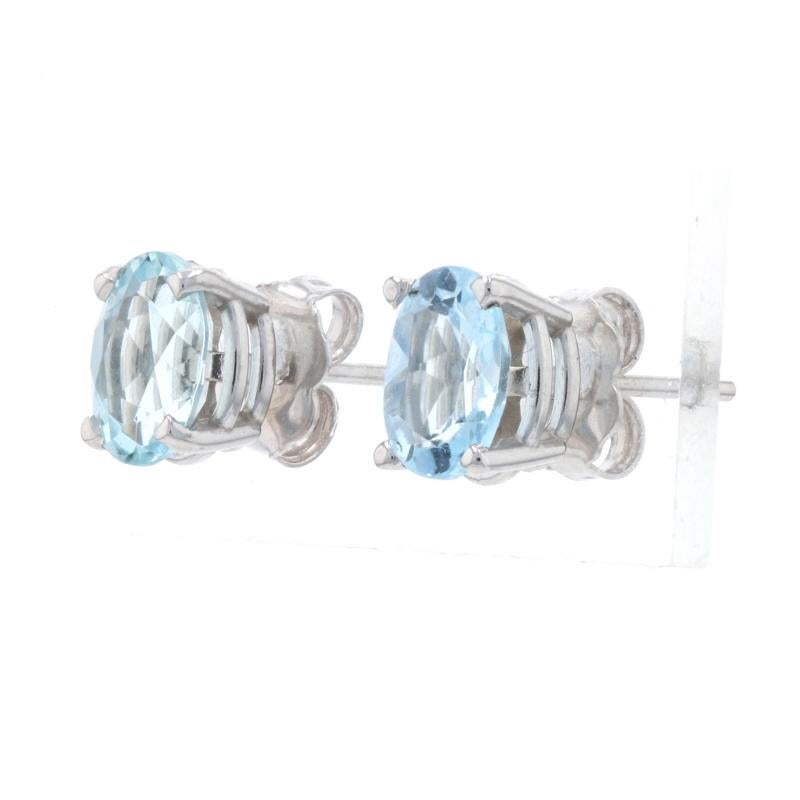 Metal Content: 14k White Gold 

Stone Information: 
Genuine Aquamarines
Treatment: Heating
Total Carats: 1.50ctw
Cut: Oval 
Color: Blue

Style: Stud 
Fastening Type: Butterfly Closures

Measurements: 
Tall: 5/16