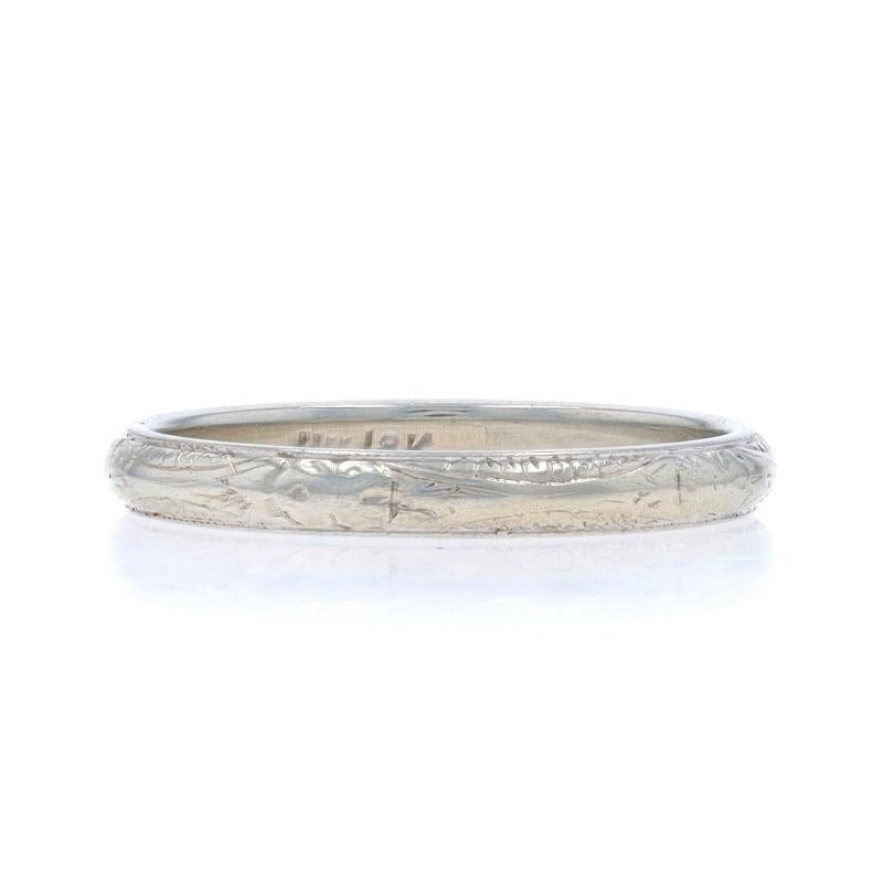 Size: 7 1/2

Era: Art Deco

Metal Content: 18k White Gold

Style: Wedding Band without Stones
Theme: Floral
Features: Etched Detailing Spanning the Entire Perimeter

Measurements

Face Height (north to south): 1/8