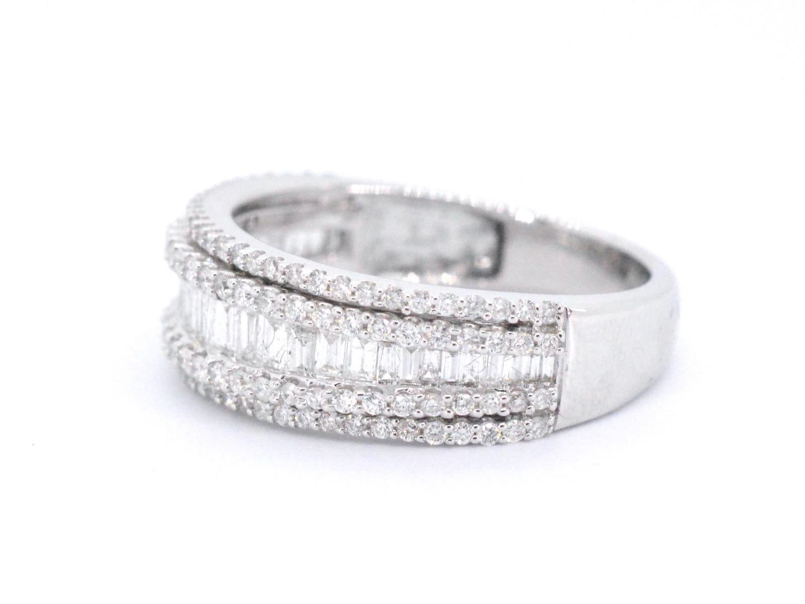 This white gold band ring is made from 14K white gold, a high-quality metal that is known for its strength and durability. The band features five rows of diamonds, with a combination of brilliant and baguette cuts that are selected for their