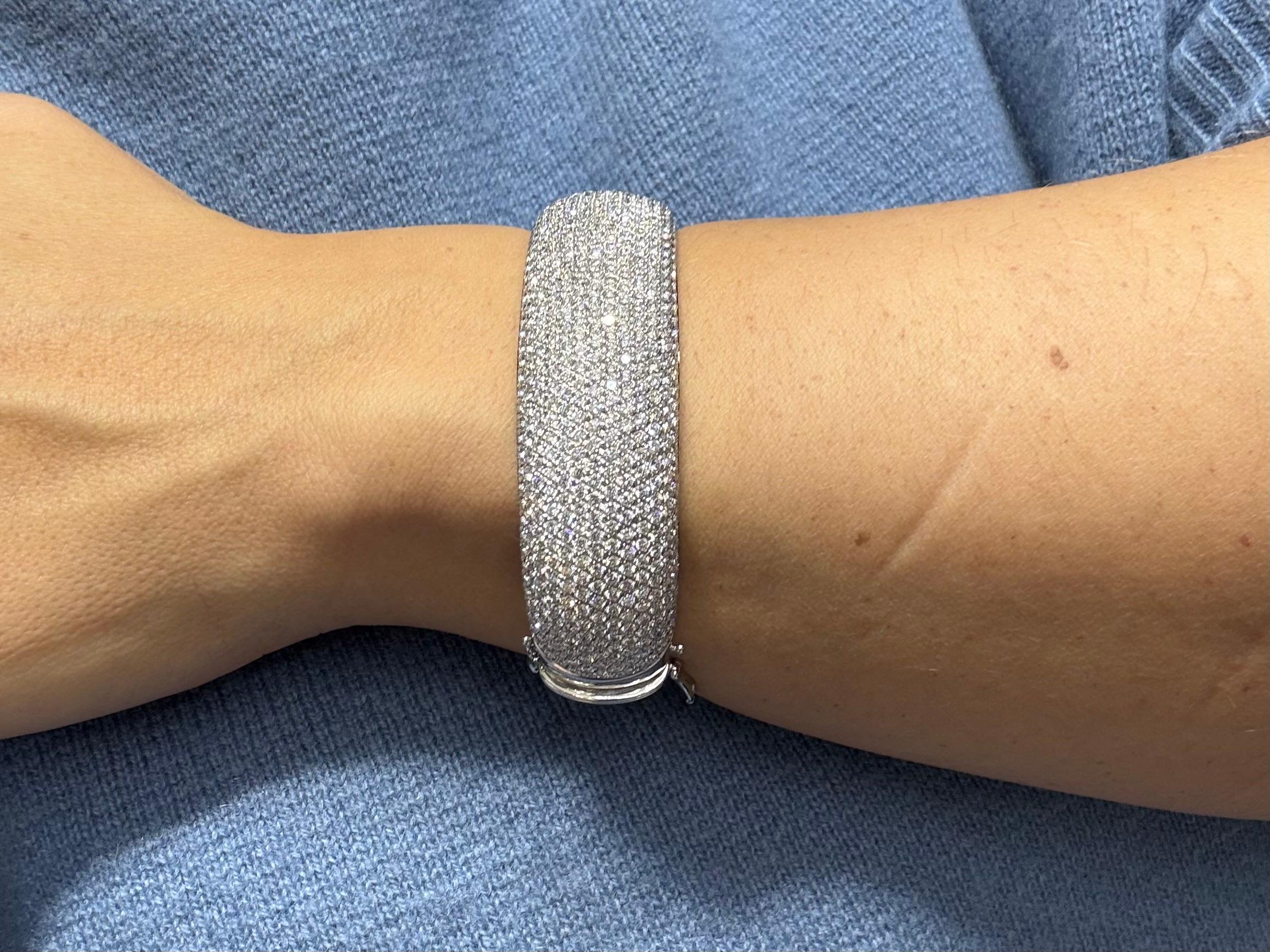 This exquisite White Gold Bangle Bracelet is a true masterpiece of fine jewelry, featuring 16.18 carats of natural diamonds. Crafted from polished white gold, the bangle is adorned with an impressive **576 pavé-set diamonds**, each carefully chosen