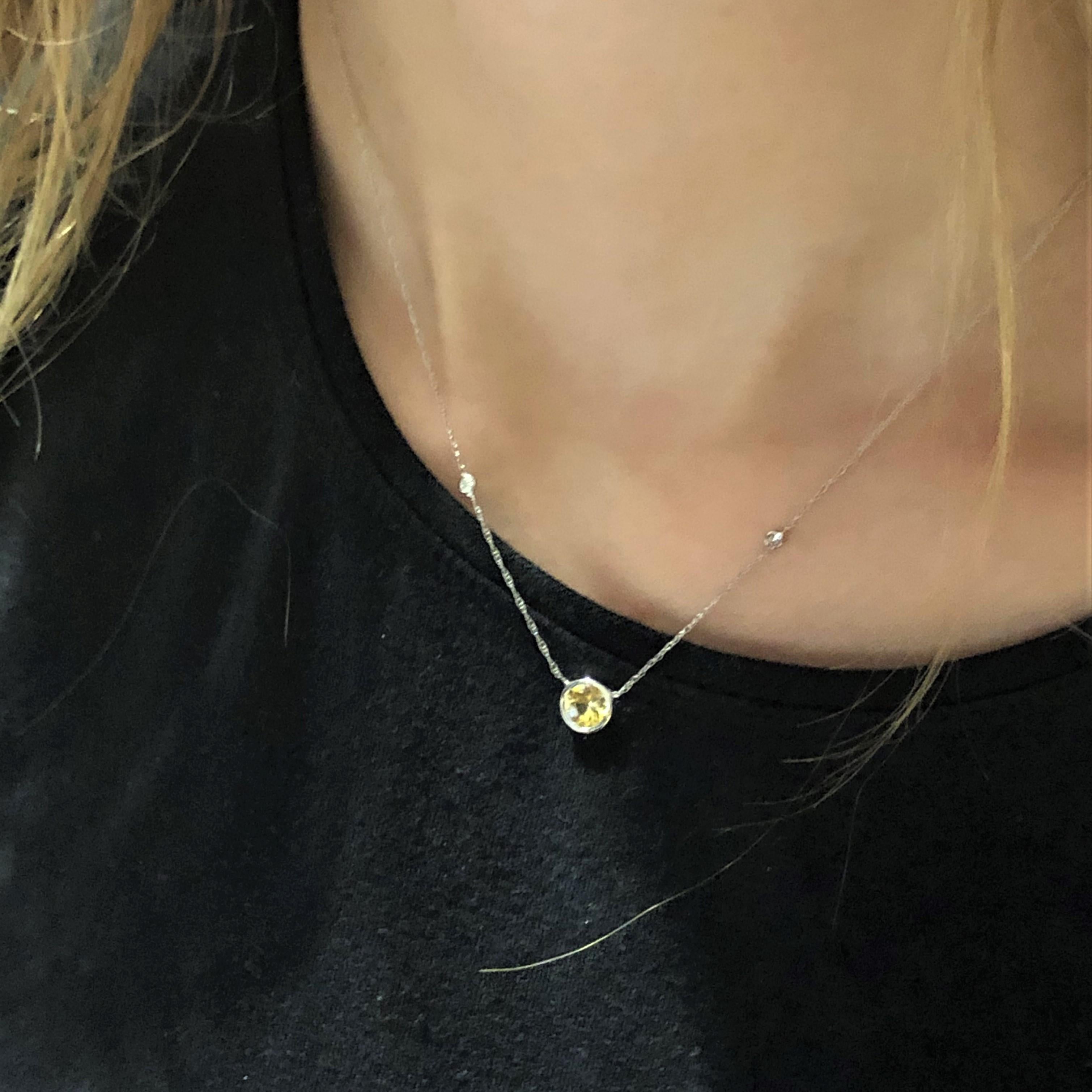 14 karat white gold necklace pendant with one yellow sapphire and two round diamond 
Measuring 16 inch long
Diamond total weight 0.10 carat
Yellow Sapphire weight 0.70 carat
Bezel of Yellow sapphire measuring 0.28