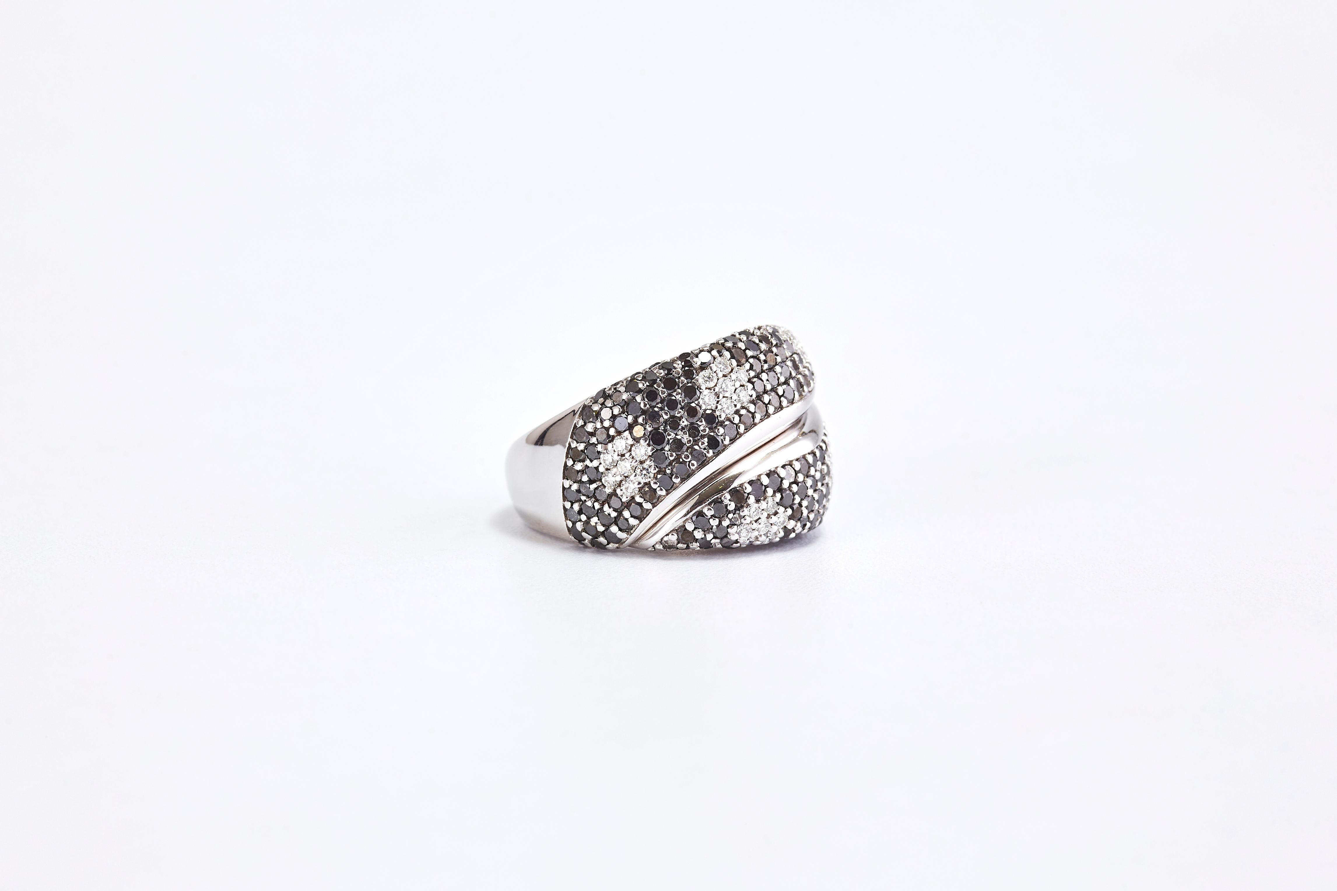 White Gold Black and White Diamond Pave Flowers Band Ring

Amazing white gold ring with high quality round cut diamonds diamonds. 
The ring has a beautiful pave of black diamonds and 6 groups of white diamonds that each forms a flower.
Black