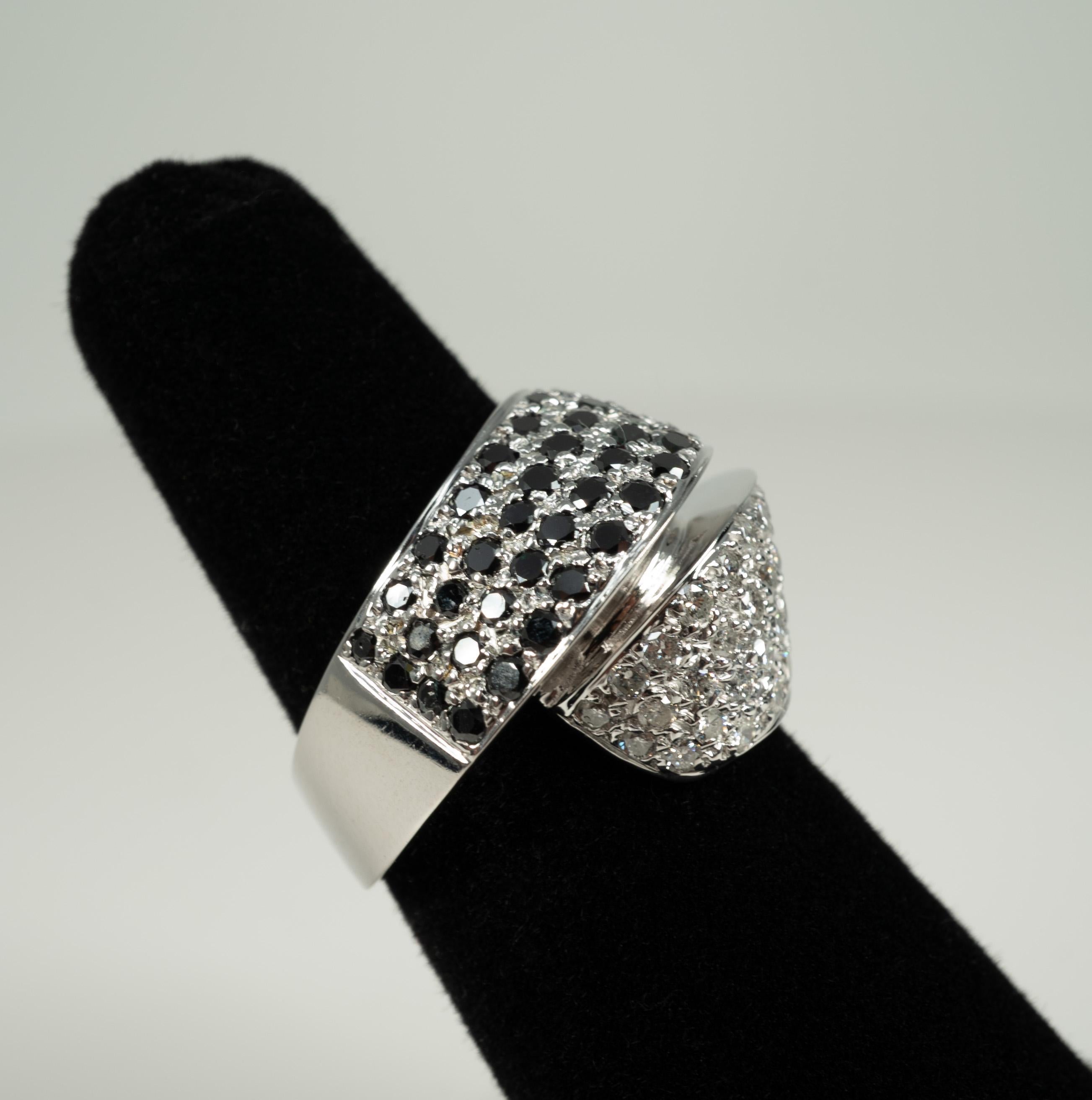 In 18 karat white gold, this beautiful by-pass ring features black and colorless diamonds!  