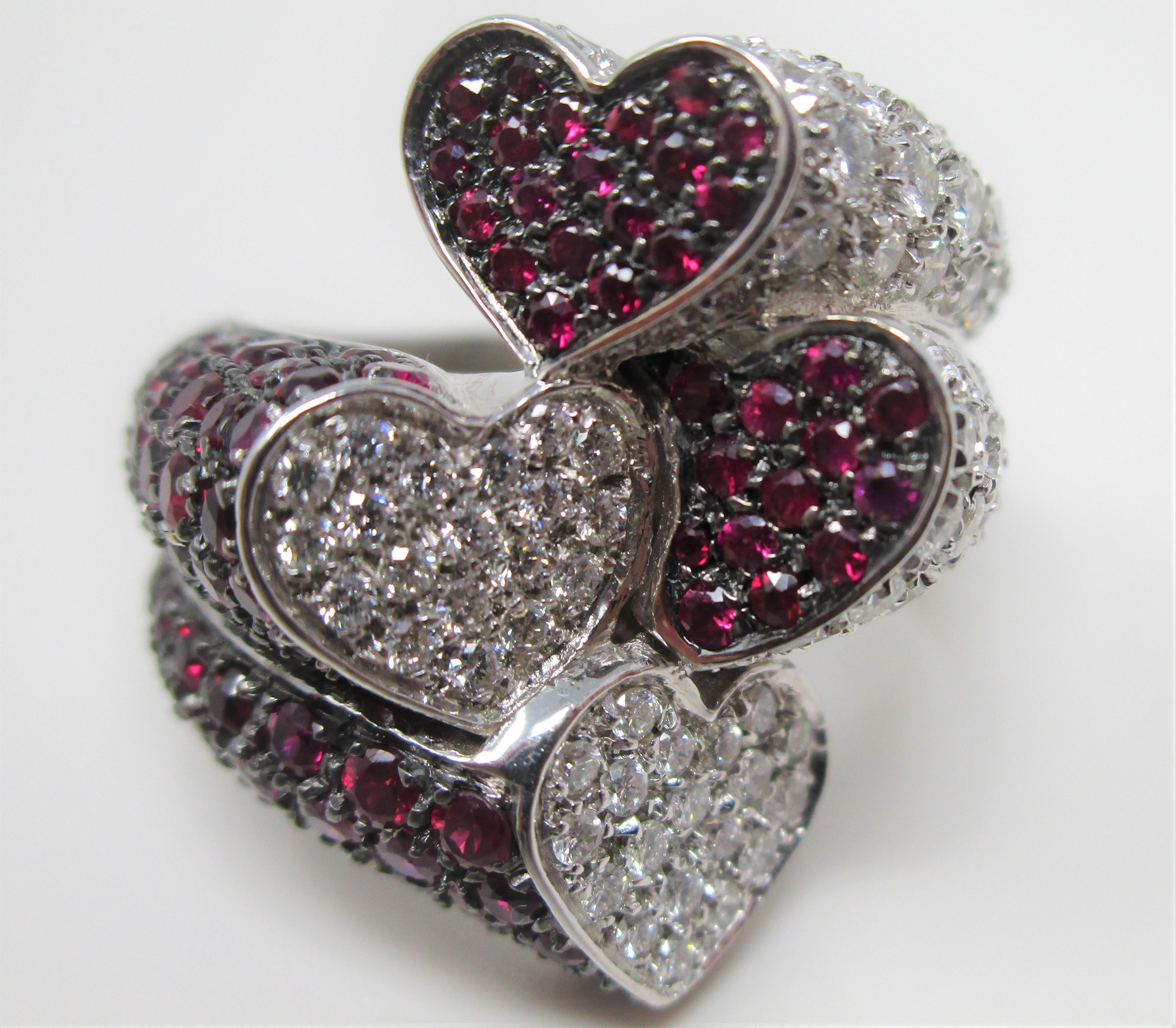 You don't have to be a heart lover to admire this ring!  In 18 karat white gold and black rhodium, with approximately 2.00 carats of diamonds and approximately 3.00 carats of rubies, this by pass ring is a stunner and very comfortable! Size 7.25.
