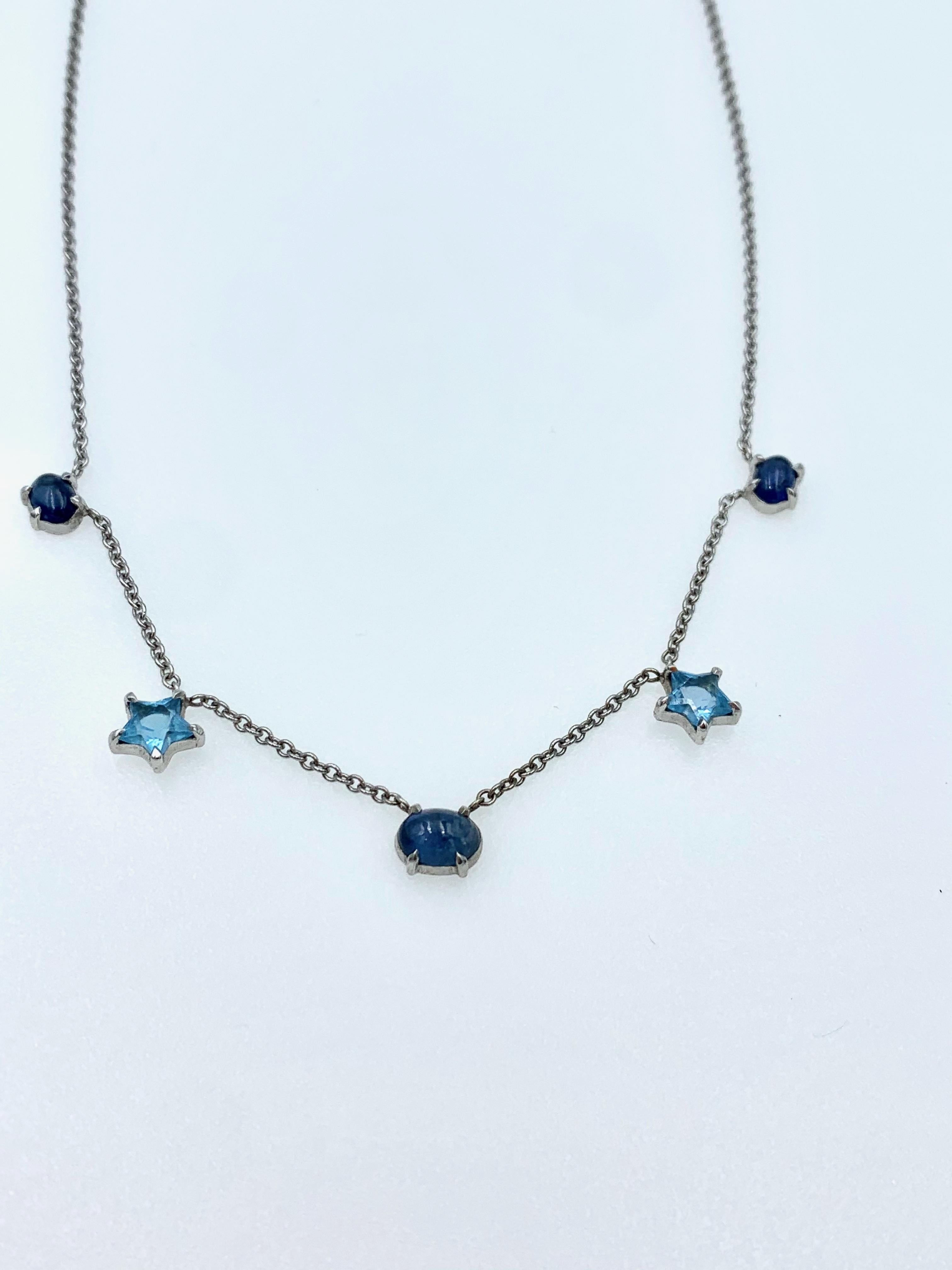 Hand made in 9 karat White gold with three oval blue Sapphire cabochons and two sky blue Topaz stars distributed throughout the necklines at a length of either 16