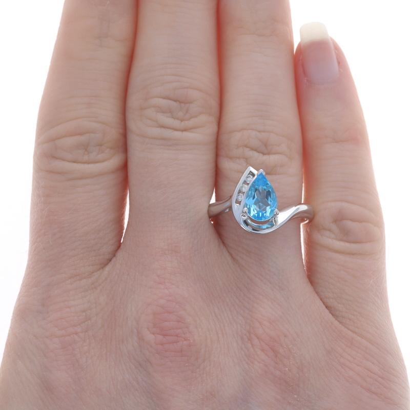 Size: 8 1/4
Sizing Fee: Up 2 sizes for $35 or Down 2 sizes for $30

Metal Content: 10k White Gold

Stone Information
Natural Blue Topaz
Treatment: Routinely Enhanced
Carat(s): 2.00ct
Cut: Pear

Natural Diamonds
Carat(s): .06ctw
Cut: Round