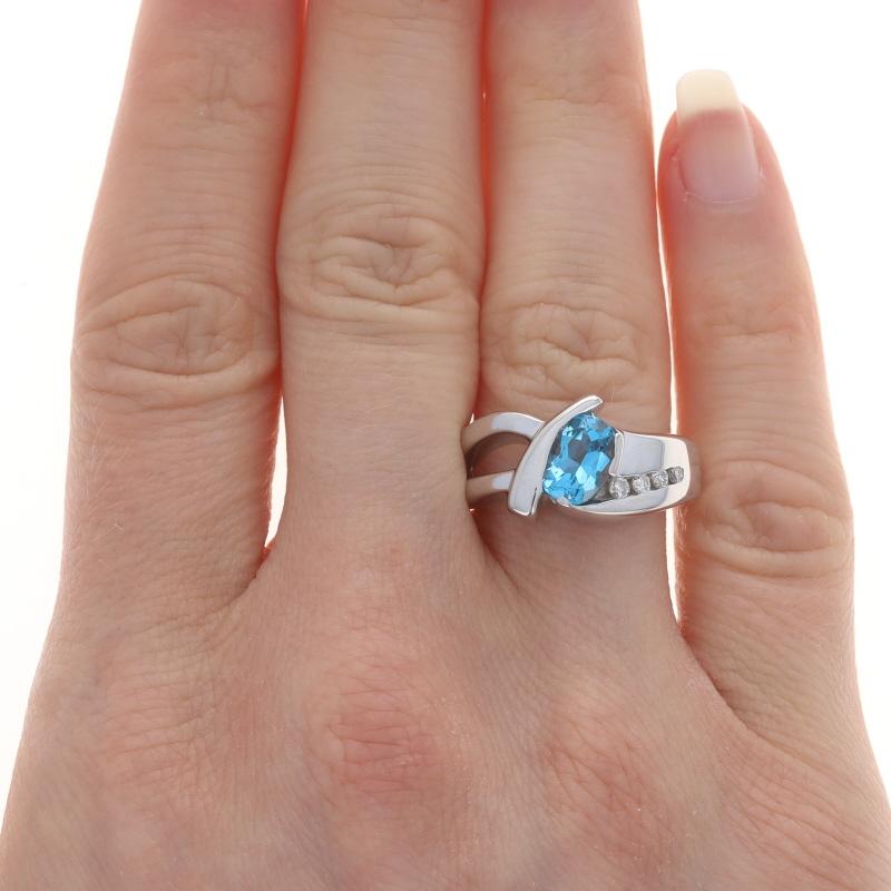 Size: 8

Metal Content: 14k White Gold

Stone Information

Natural Blue Topaz
Treatment: Routinely Enhanced
Carat(s): 2.50ct
Cut: Oval

Natural Diamonds
Carat(s): .12ctw
Cut: Round Brilliant
Color: G - H
Clarity: SI1 - SI2

Total Carats:
