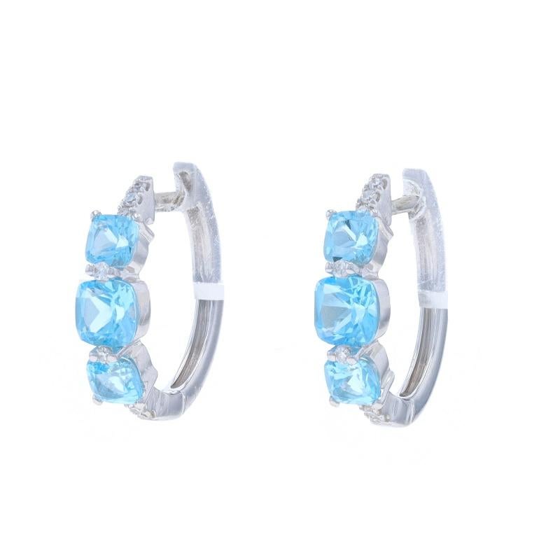 Metal Content: 14k White Gold

Stone Information

Natural Blue Topaz
Treatment: Routinely Enhanced
Carat(s): 1.30ctw
Cut: Cushion

Natural Diamonds
Carat(s): .07ctw
Cut: Single
Color: G - H
Clarity: VS1 - VS2

Total Carats: 1.37ctw

Style: Hoop,