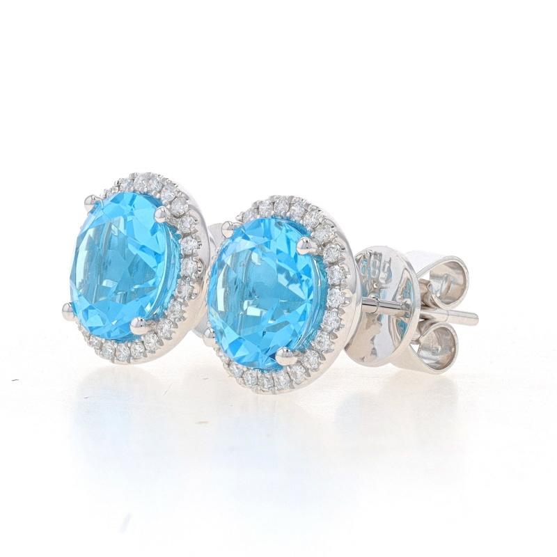 Metal Content: 14k White Gold

Stone Information
Natural Topaz
Treatment: Routinely Enhanced
Carat(s): 4.29ctw
Cut: Round
Color: Blue

Natural Diamonds
Carat(s): .20ctw
Cut: Round Brilliant
Color: G - H
Clarity: VS2 - SI1

Total Carats: