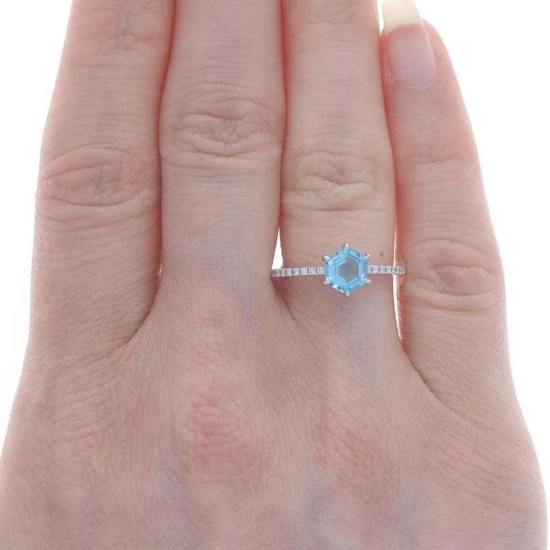 Size: 7
Sizing Fee: Up 2 sizes for $40 or Down 1 size for $40

Metal Content: 14k White Gold

Stone Information
Natural Topaz
Treatment: Routinely Enhanced
Carat(s): 1.23ct
Cut: Hexagon
Color: Blue

Natural Diamonds
Carat(s): .10ctw
Cut: Round