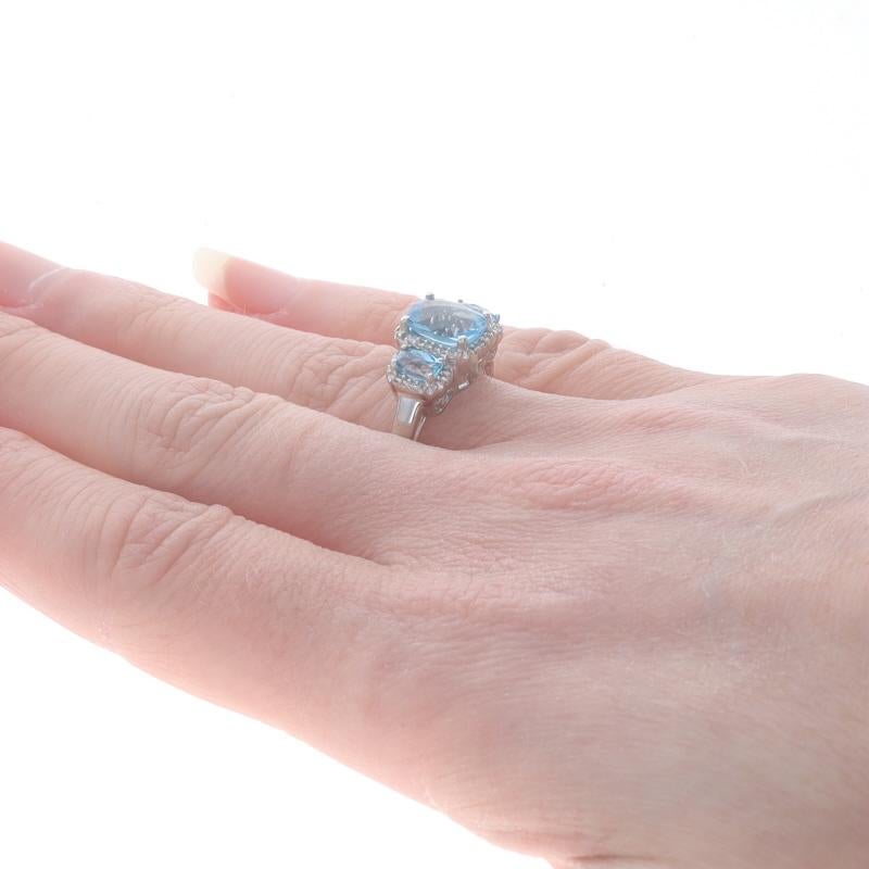 Women's White Gold Blue Topaz & Diamond Three-Stone Halo Ring - 10k Rect Cushion 2.45ctw For Sale
