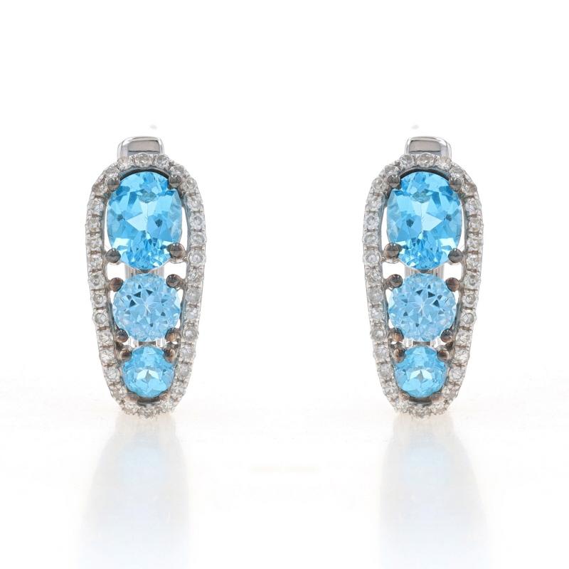 Metal Content: 14k White Gold

Stone Information
Natural Blue Topaz
Treatment: Routinely Enhanced
Carat(s): 1.84ctw
Cut: Oval & Round

Natural Diamonds
Carat(s): .20ctw
Cut: Single
Color: G - H
Clarity: VS2 - SI1

Total Carats: 2.04ctw

Style: