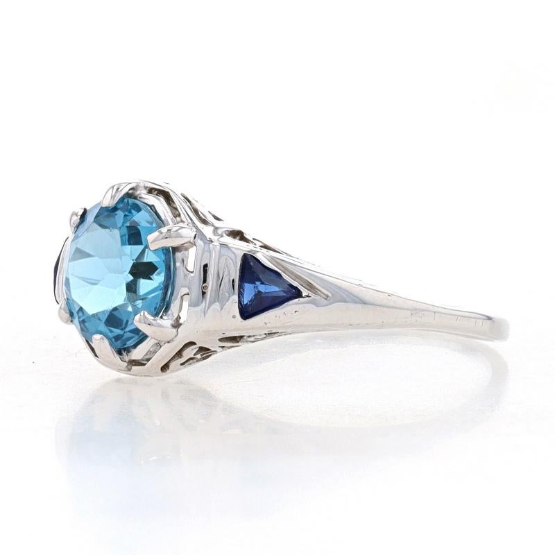 Size: 6 1/4
Sizing Fee: Up 1 size for $35

Era: Art Deco
Date: 1920s - 1930s (center stone is newer than setting)

Metal Content: 14k White Gold

Stone Information
Natural Blue Topaz
Treatment: Routinely Enhanced
Carat(s): 1.55ct
Cut: