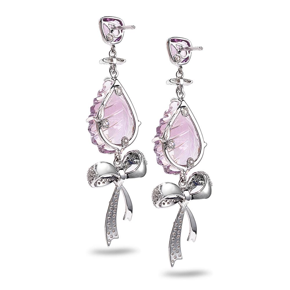 One-Of-A-Kind 18 karat White Gold Bow Earrings with 1.60 Carat Purple Sapphire, 19.20 Carat Amethyst, and 0.87 Carat Diamonds. This collection is inspired by the unity of life on the banks of the Ganges River in India. All of the living things at