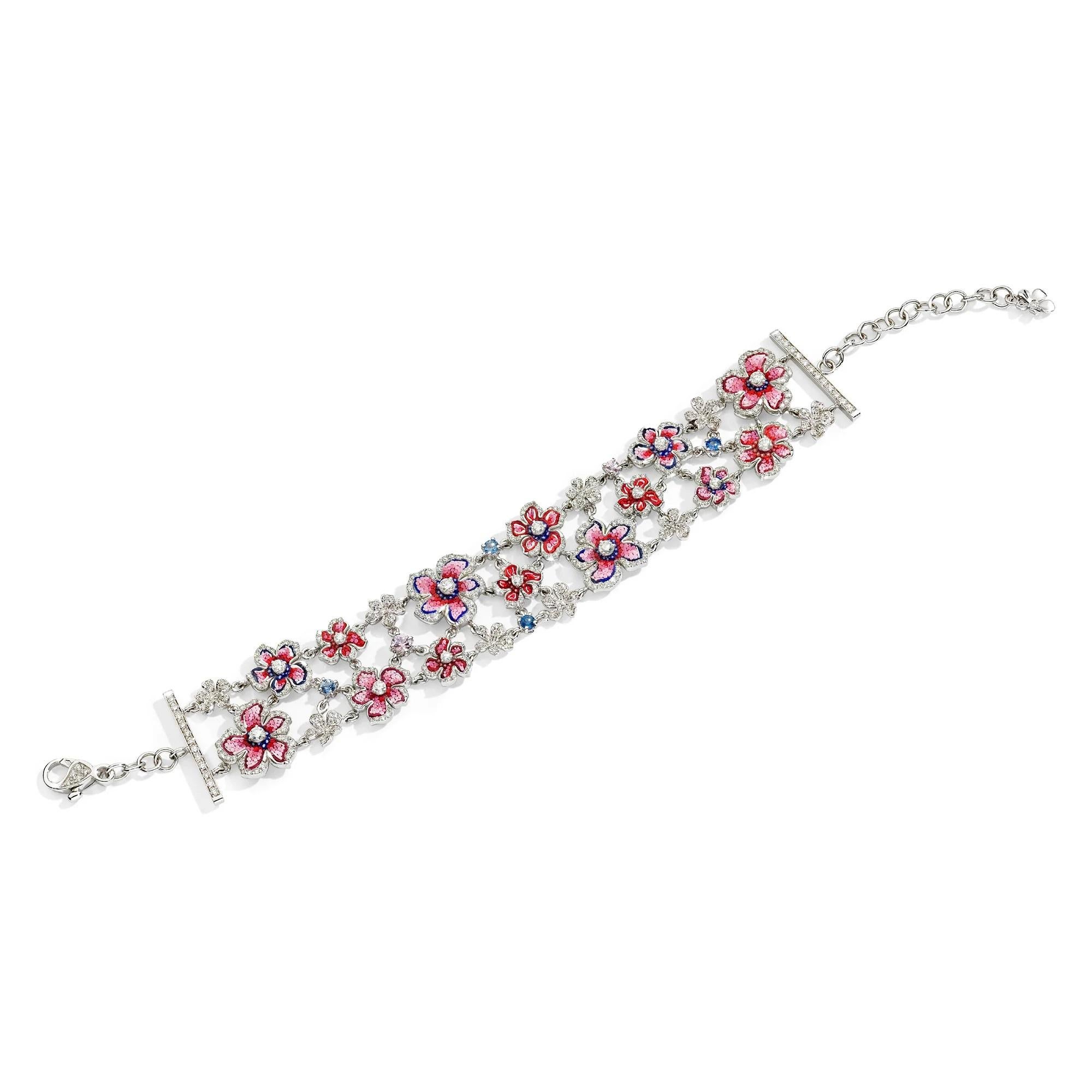 Wrap your wrist with the graceful Giardino Primavera bracelet, encompassing beautifully crafted pink and red flowers made with bright colored micromosaics. 
Intertwined between the blooms are enchanting blue and pink sapphires and dazzling white