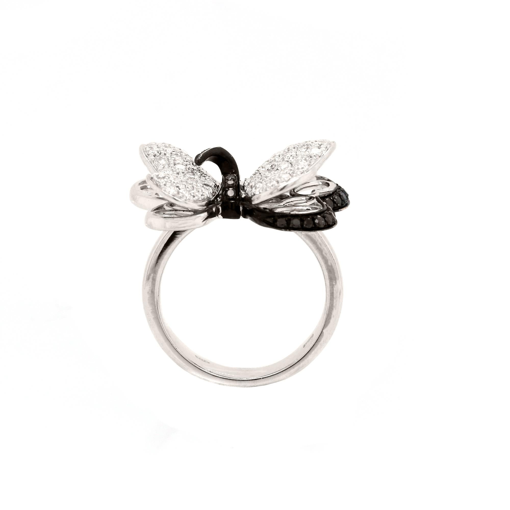 18K White Gold Butterfly Ring with Black and White Diamonds

3D butterfly ring features white diamonds in the face with black diamonds as the accents to give it the 3D design

1.50 carat Diamonds total weight

Ring is a size 7. Sizable.

Ring face